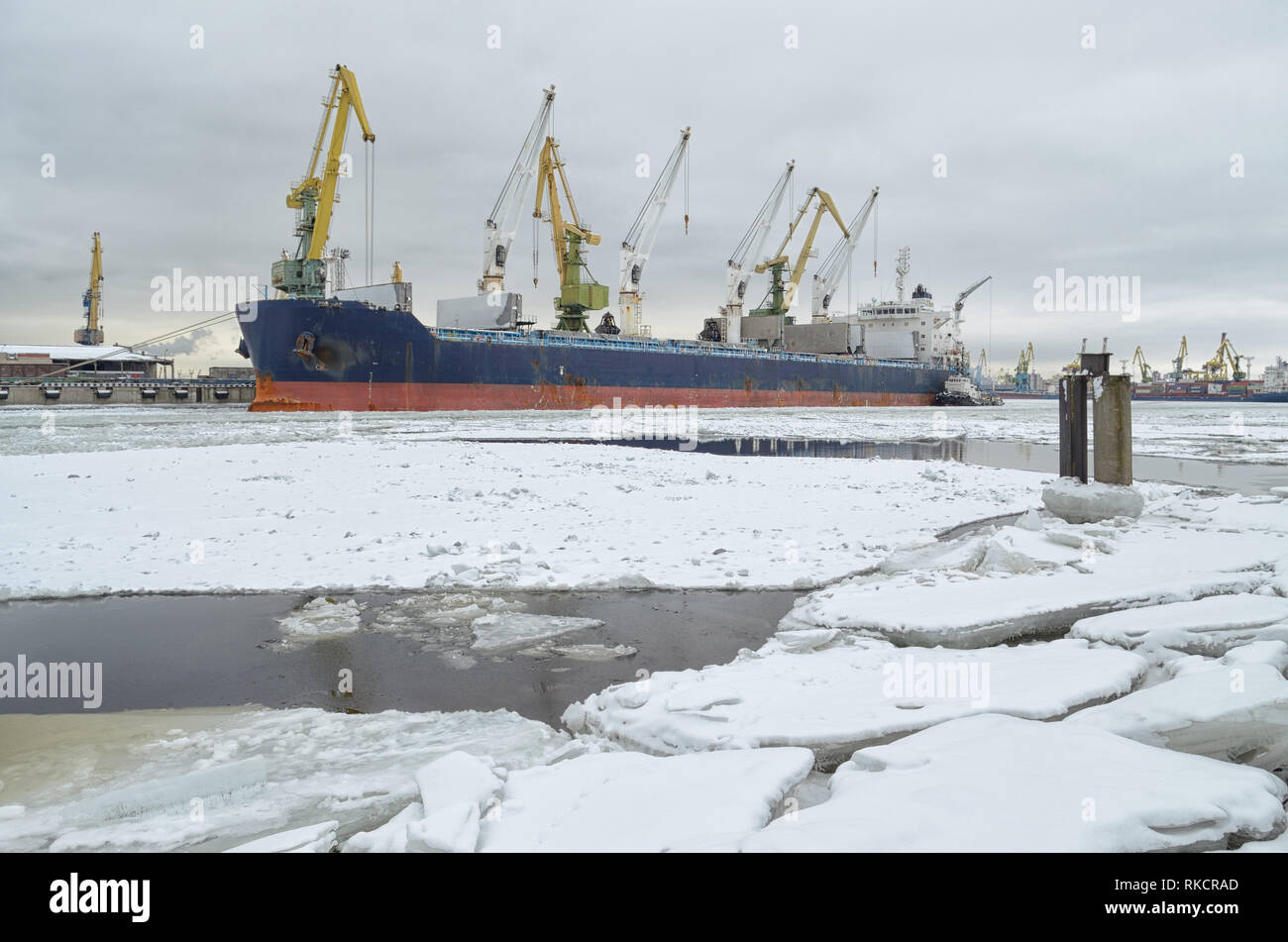 Snowing Container Port Natural landscape in the cargo port.The water in the Bay is covered ...