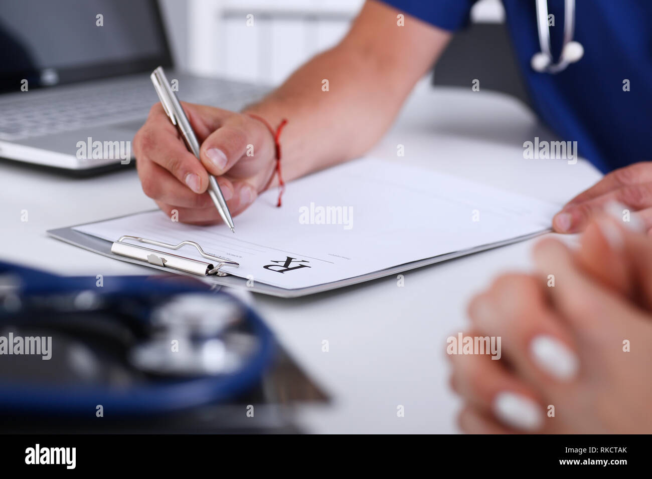 Male doctor hand write prescription at office worktable Stock Photo Alamy