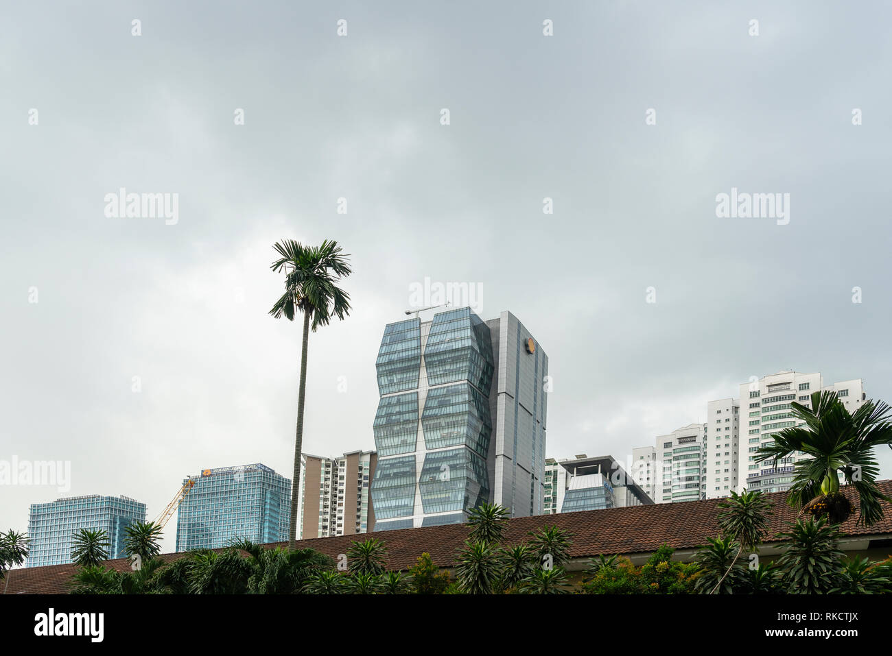 Kuala Lumpur, Malaysia. January 2019.  The skyscrapers between the vegetation Stock Photo