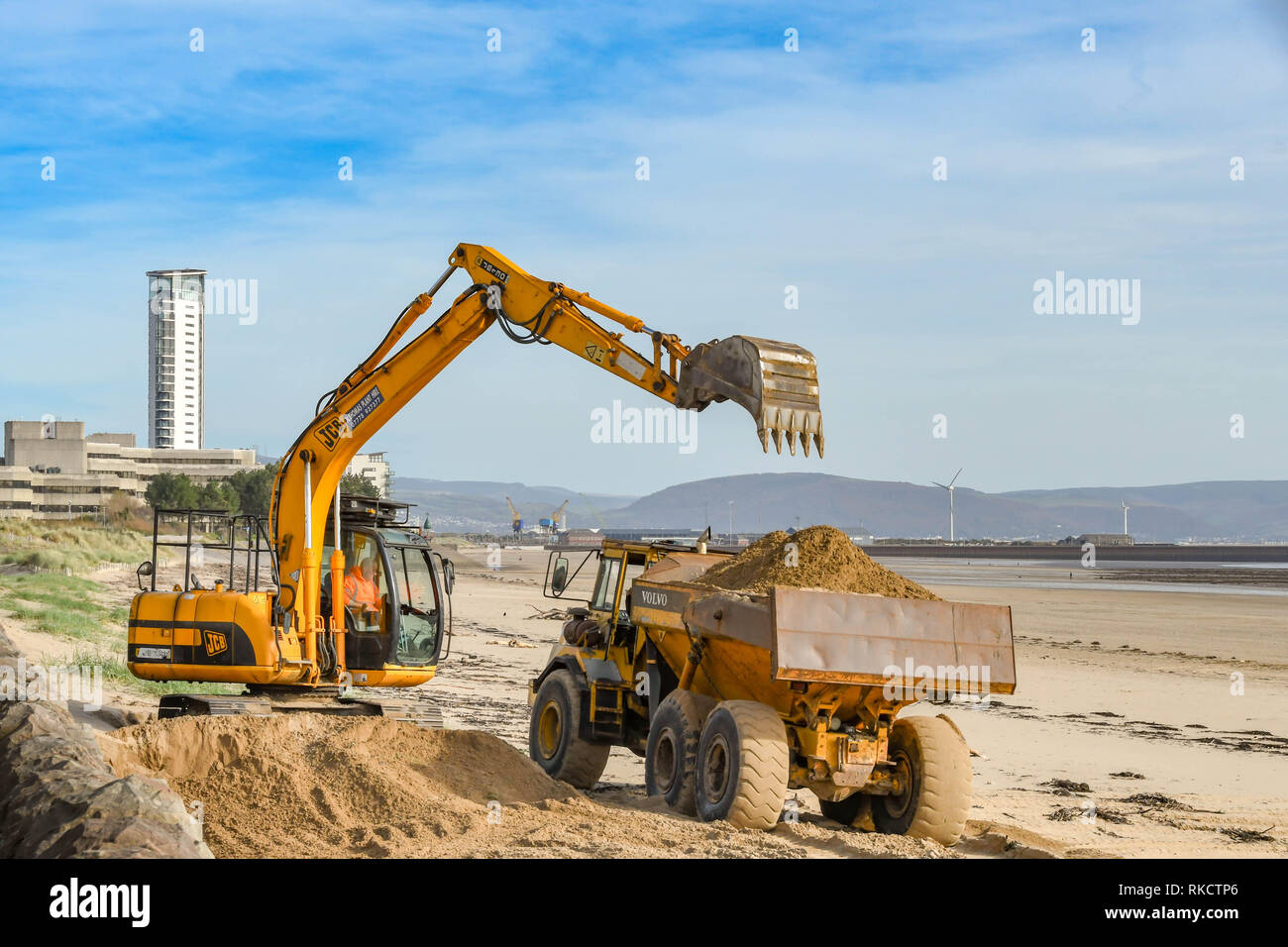 Excavator on a beach hires stock photography and images Alamy