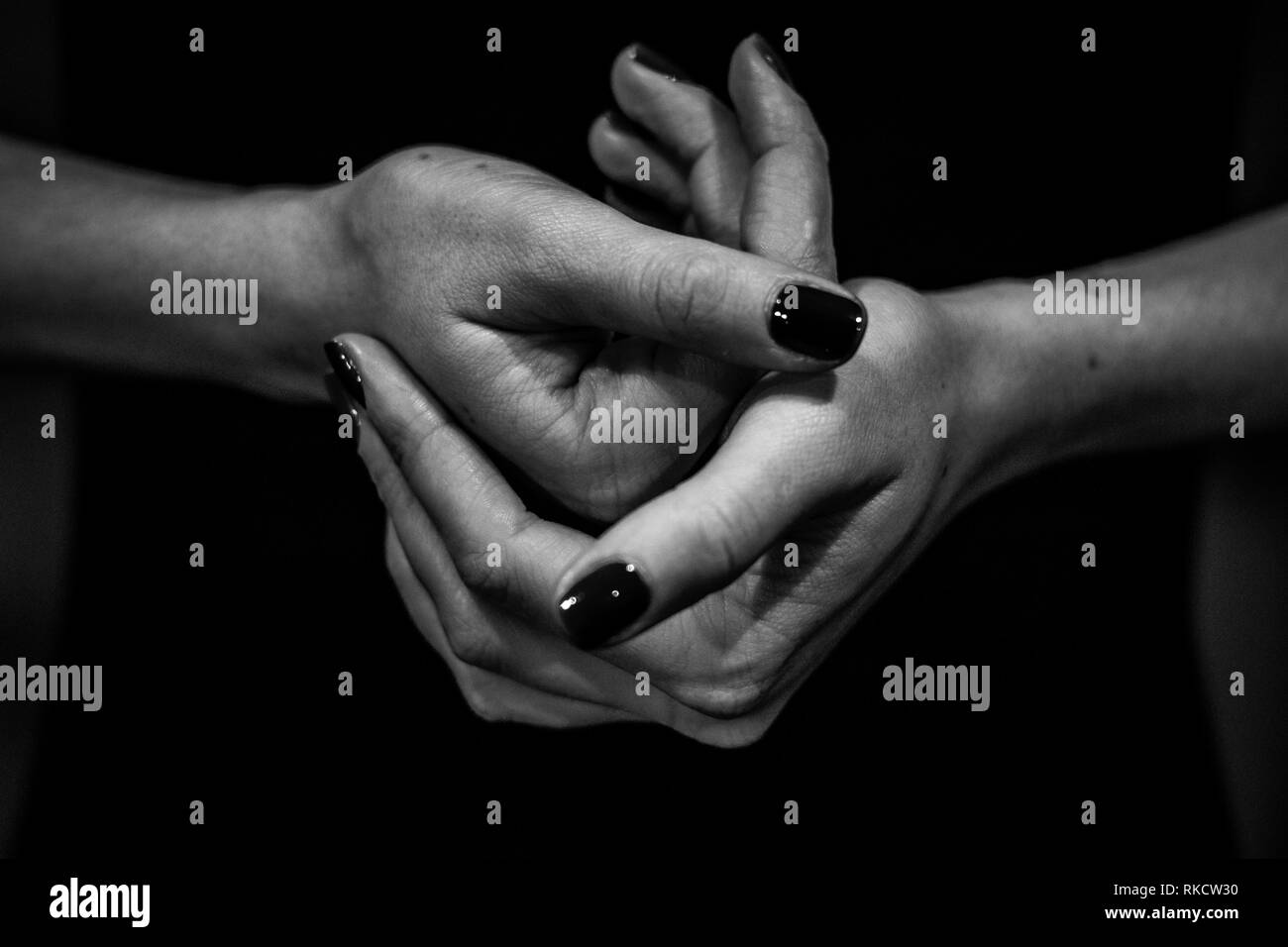 Black and white close up image of women hands holding dogether. Togetherness and peacefull Stock Photo