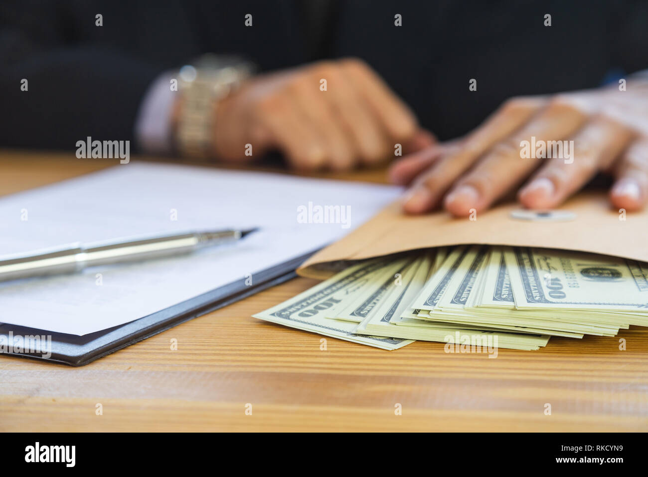 Business man signing a contract. Owns the business sign personally,director of the company, solicitor. Real estate agent holding house, moving home or Stock Photo