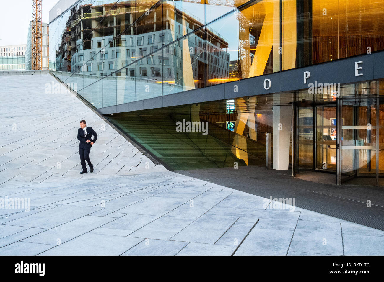 Man in black suit outside the norwegian opera house in Oslo Stock Photo