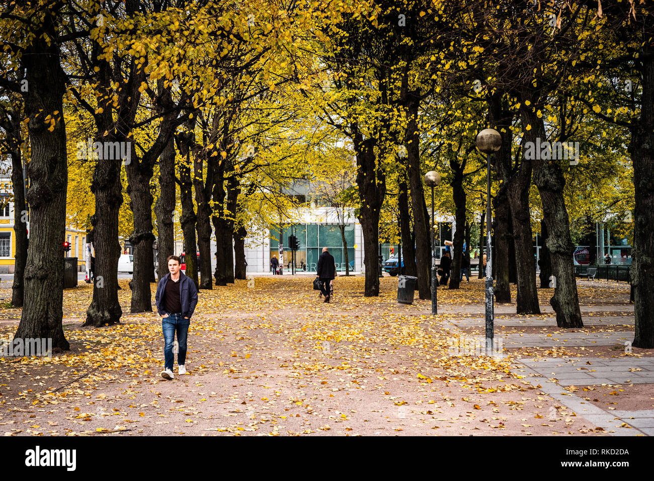 People walking through a small park in central Oslo, Norway, in the autumn fall season Stock Photo
