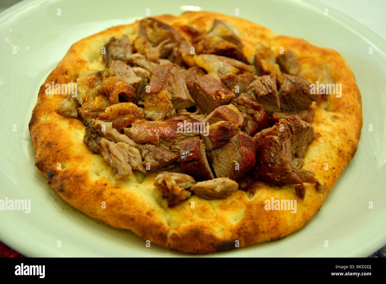 Buryan (lamb slow-cooked in a pit) served on a flat bread in Turkey. Stock Photo