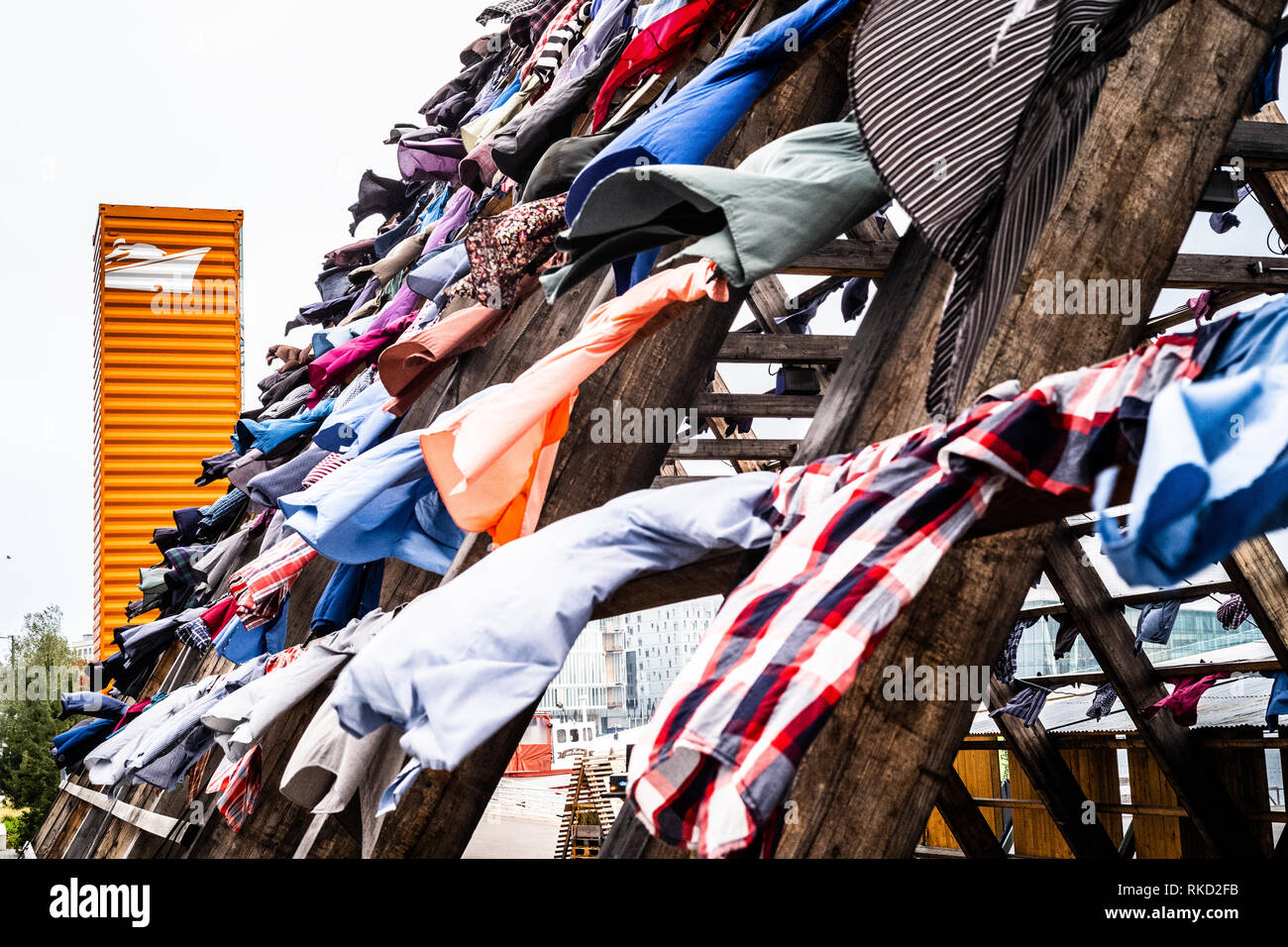 Special outdoor art project in Oslo called The Nomadic art project where 1000s of shirts hang outside on gigantic wooden poles at the Salt venue. Stock Photo