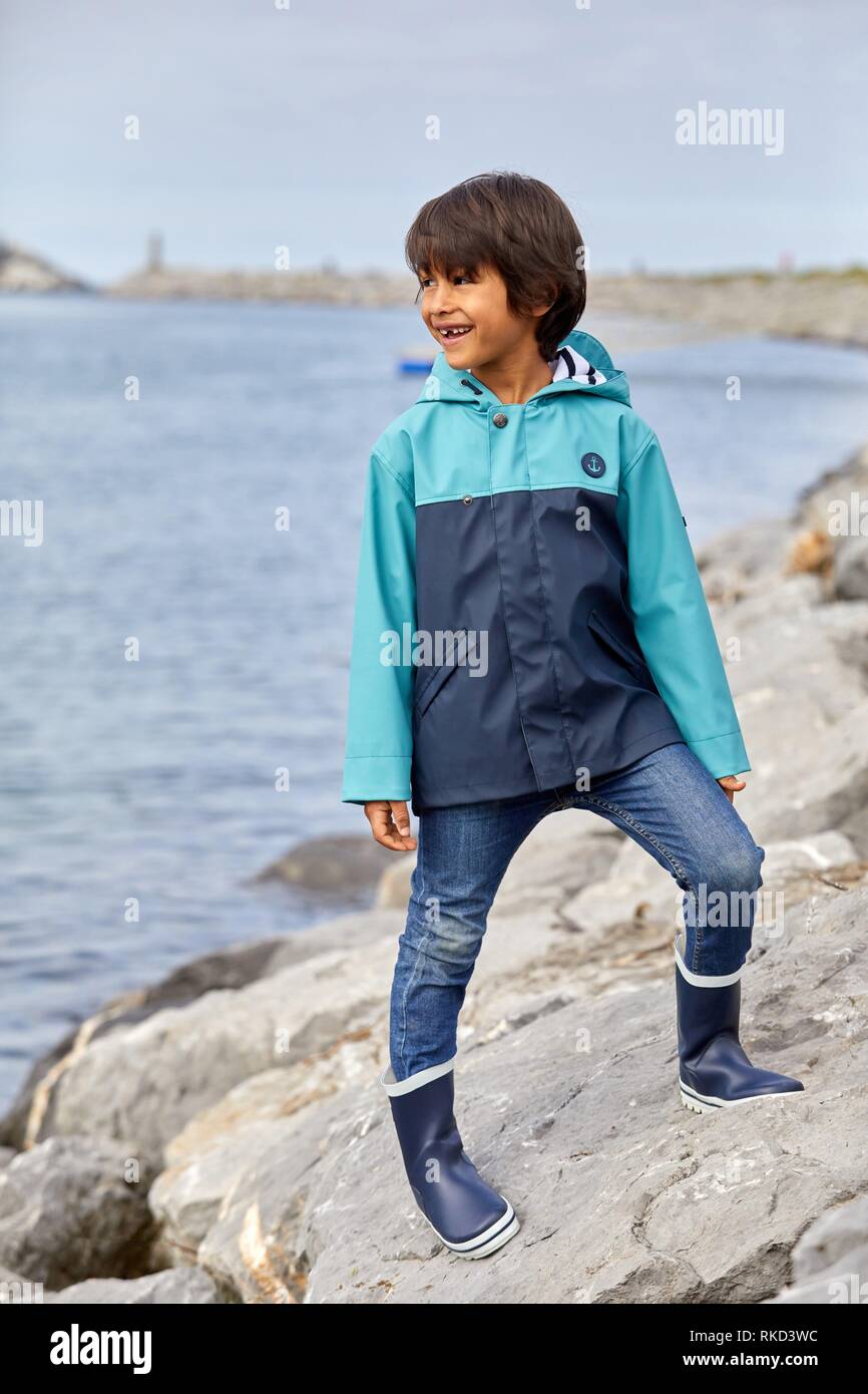 Child with raincoat, Marina Urola, Santiago beach, Zumaia, Gipuzkoa, Basque Country, Spain, Europe Stock Photo