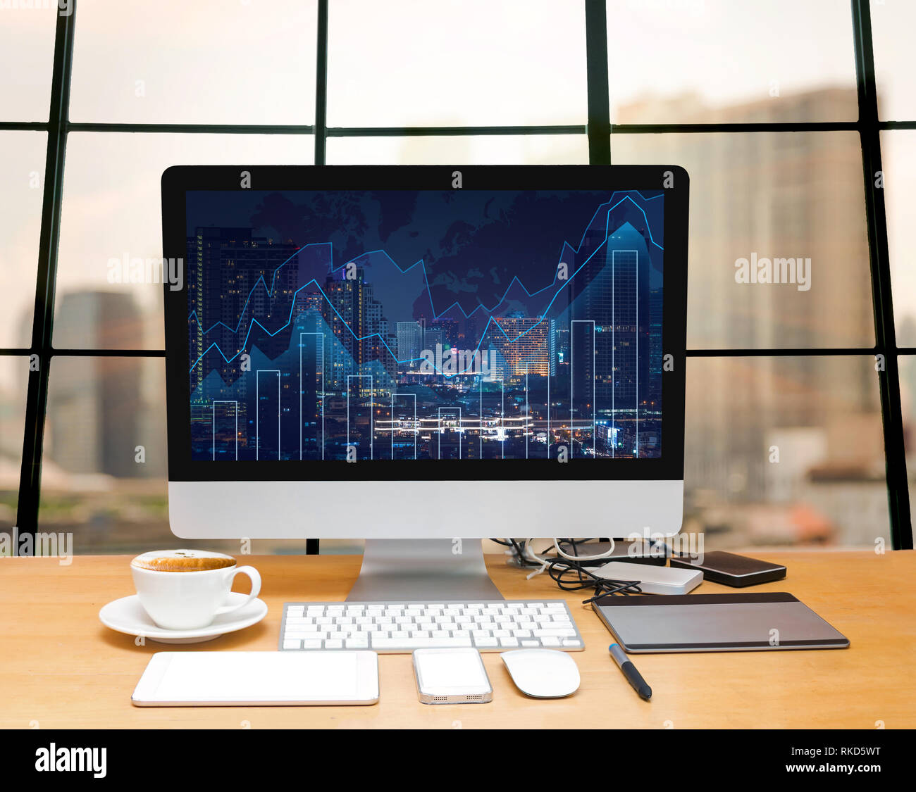 Workspace with computer desktop on the wood table with trading graph at