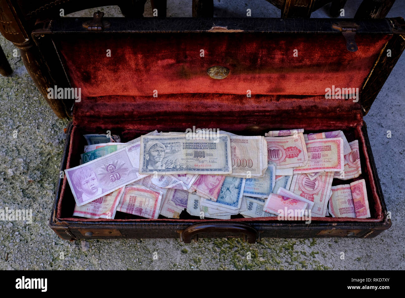 Old Yugoslavian dinars in the red suitcase at the Bascarsija bazaar in Sarajevo, Bosnia and Herzegovina. Stock Photo