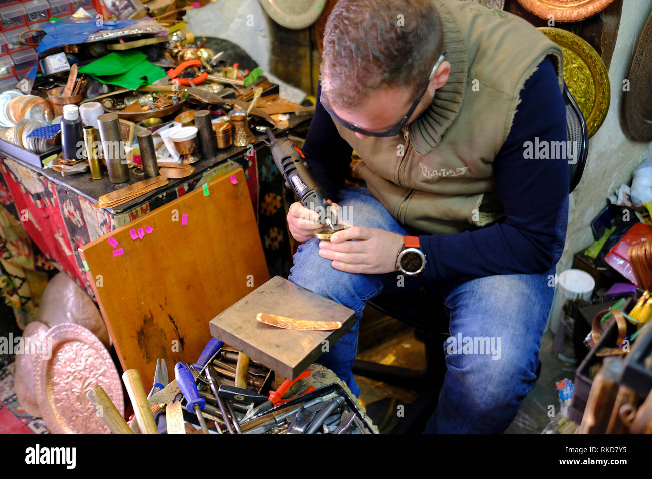 A man engraving souvenirs at the Bascarsija bazaar in Sarajevo, Bosnia and Herzegovina. Stock Photo