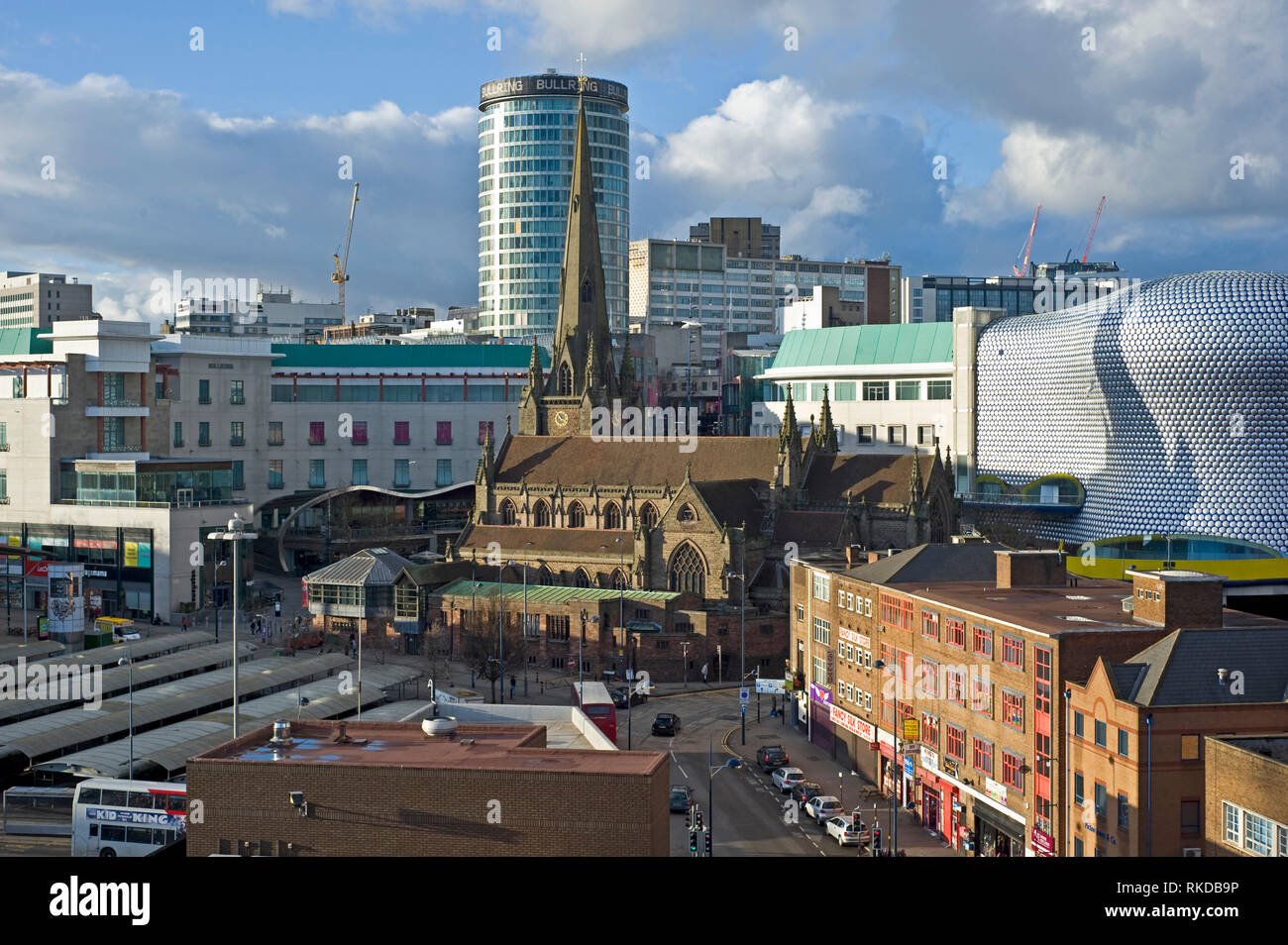 Skyline of Birmingham city centre where Grade-II listed Rotunda building is visible behind the Church of St Martins in the Bull Ring. Stock Photo