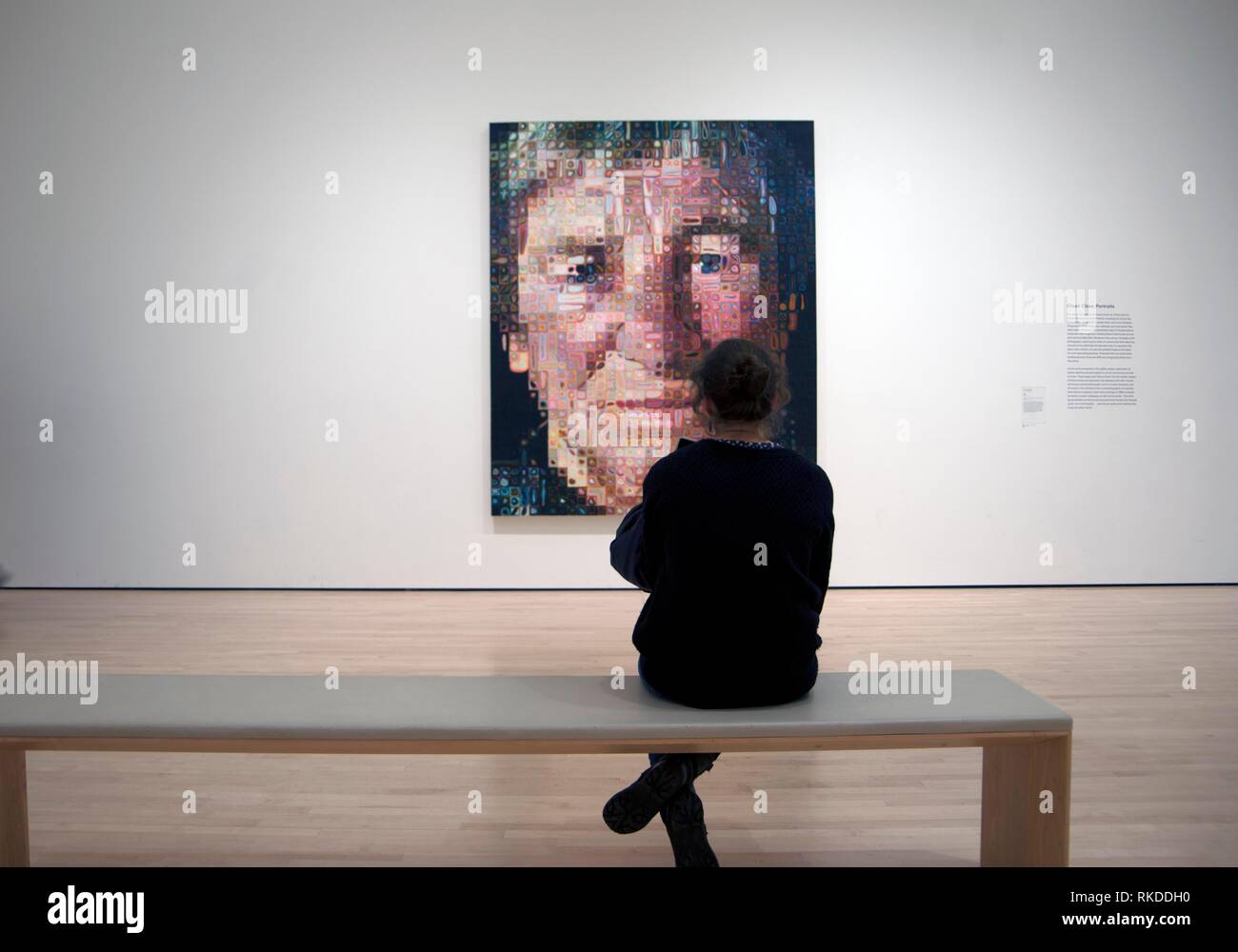 A woman studies 'Agnes' by Chuck Close at the San Francisco Museum of Modern Art. Stock Photo