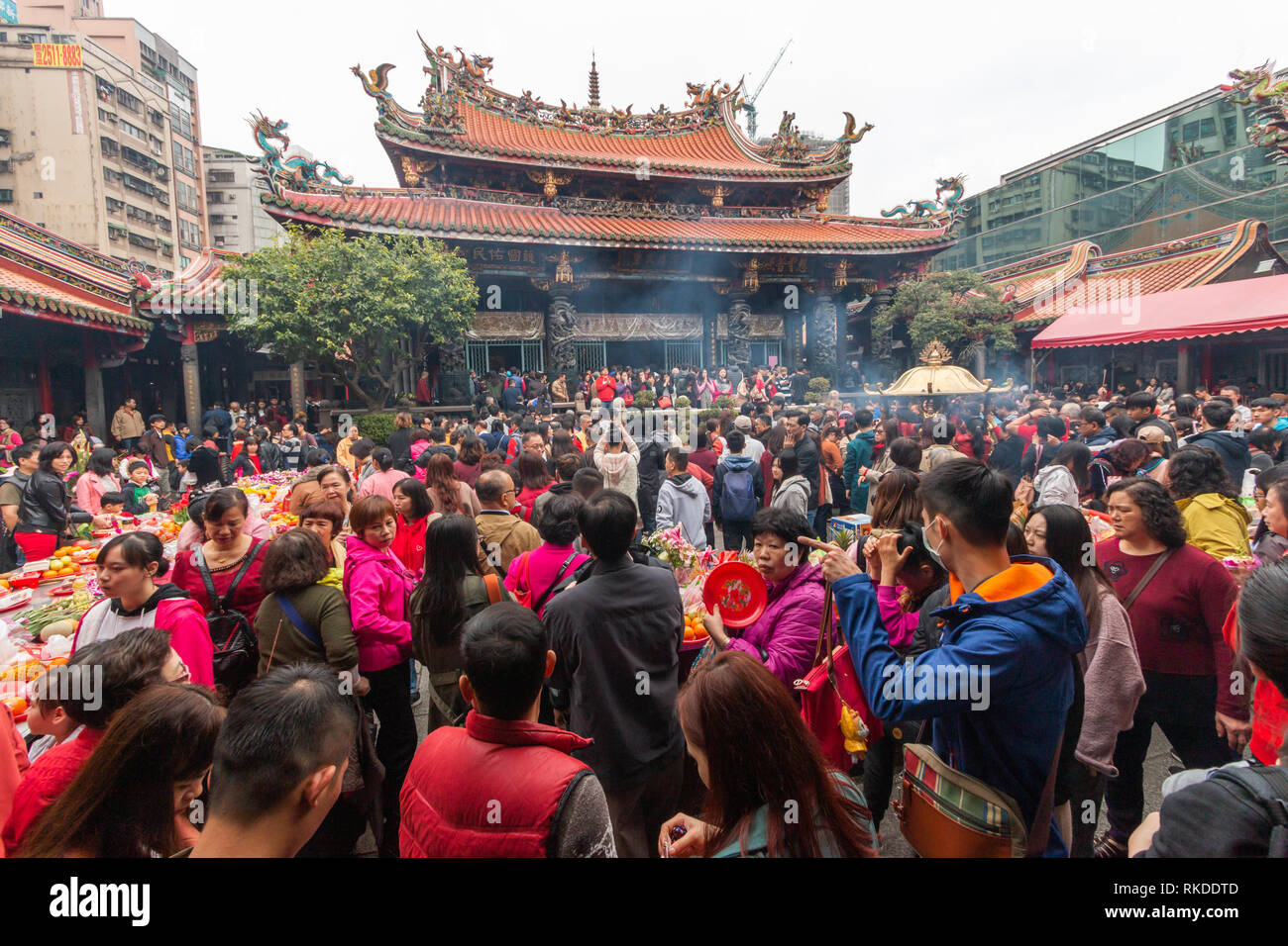 Smoke spreads around Longshan Temple in Taipei on Lunar New Year’s Day as visitors burn incense and pray to mark he arrival of the Year of the pig. Stock Photo