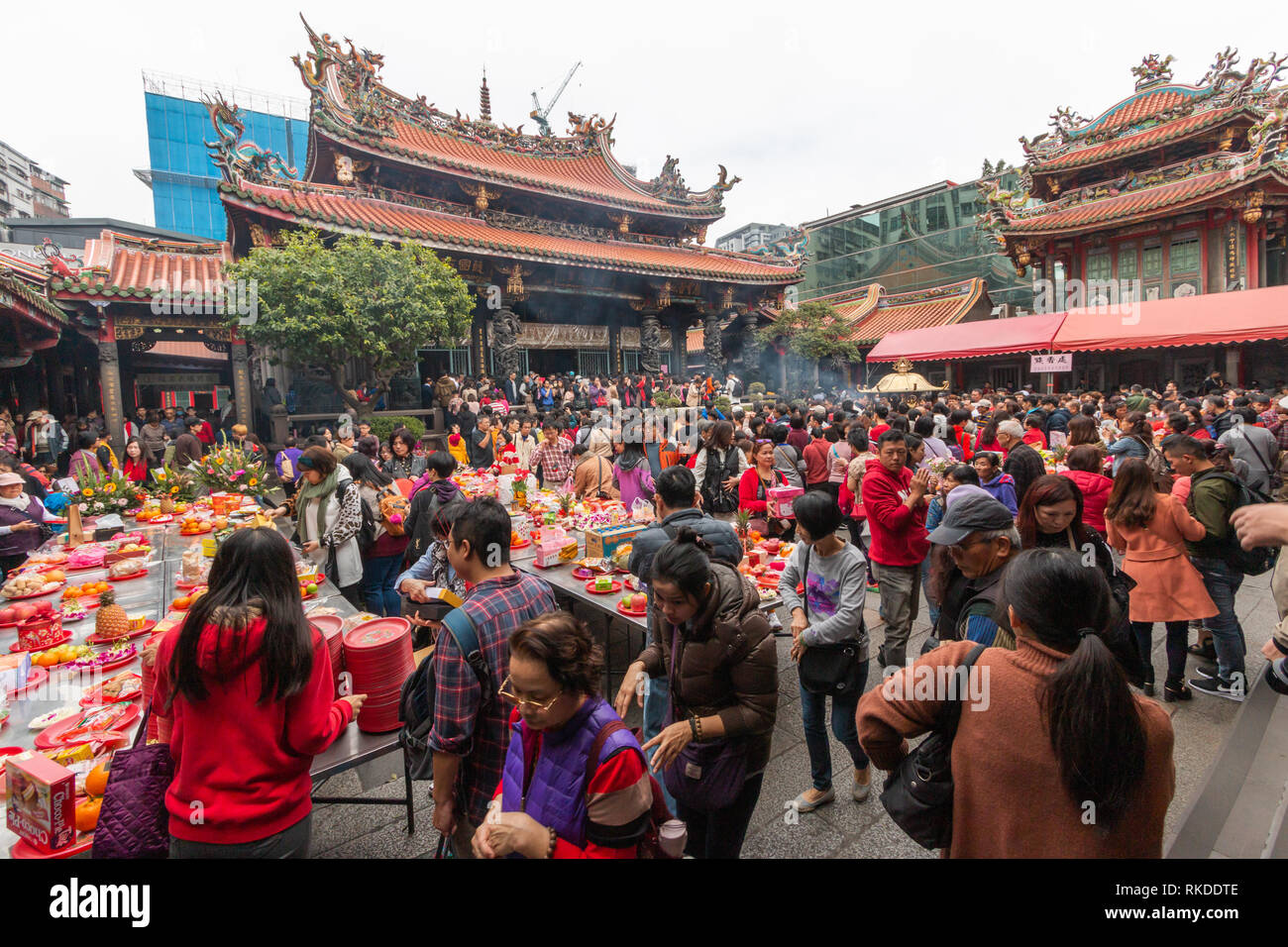 Smoke spreads around Longshan Temple in Taipei on Lunar New Year’s Day as visitors burn incense and pray to mark the arrival of the Year of the pig. Stock Photo