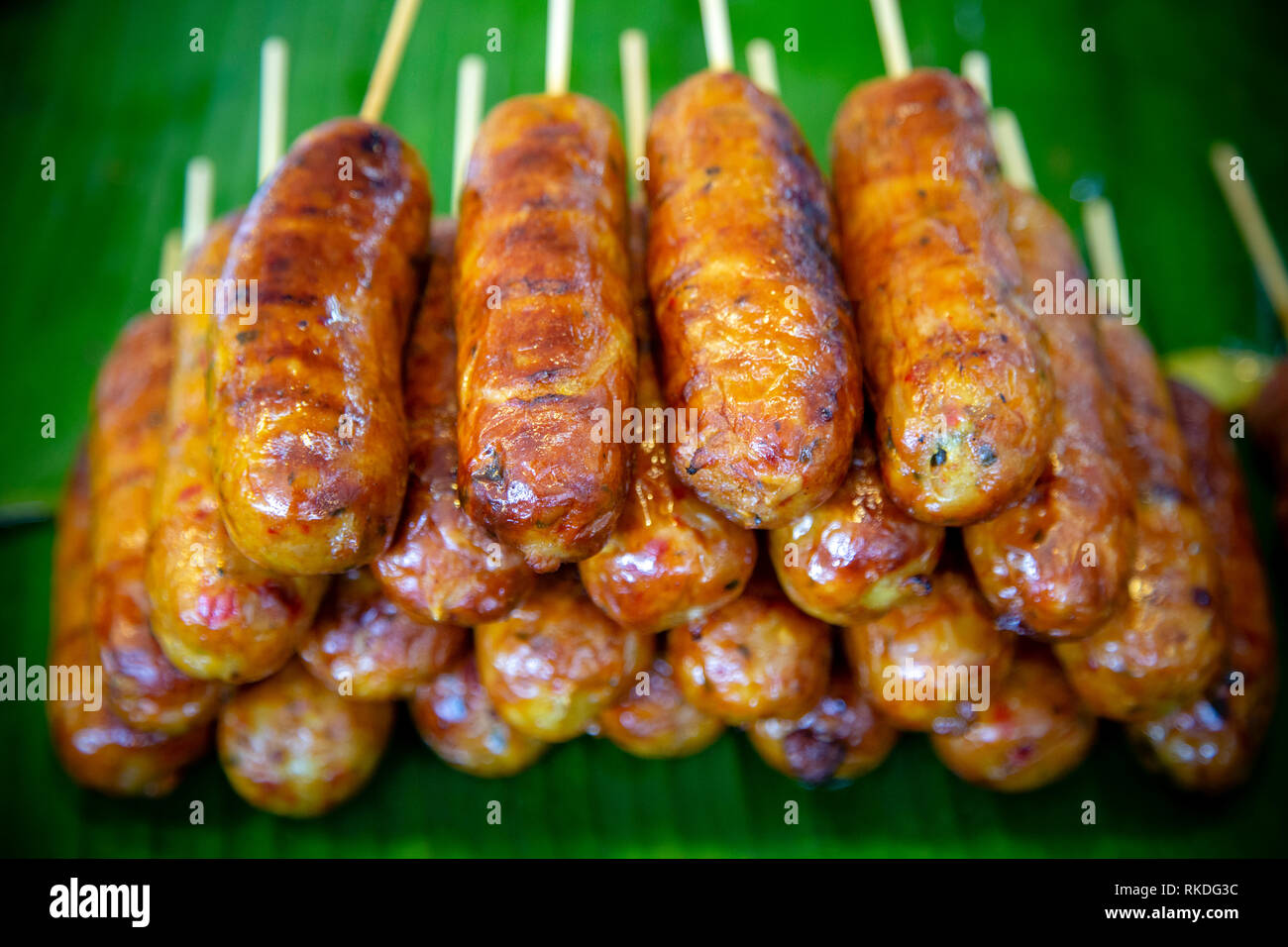Sai ua or northern Thai sausage or Chiang Mai sausage is a grilled pork sausage from northern Thailand and northeastern Burma. Sai ua contains minced  Stock Photo
