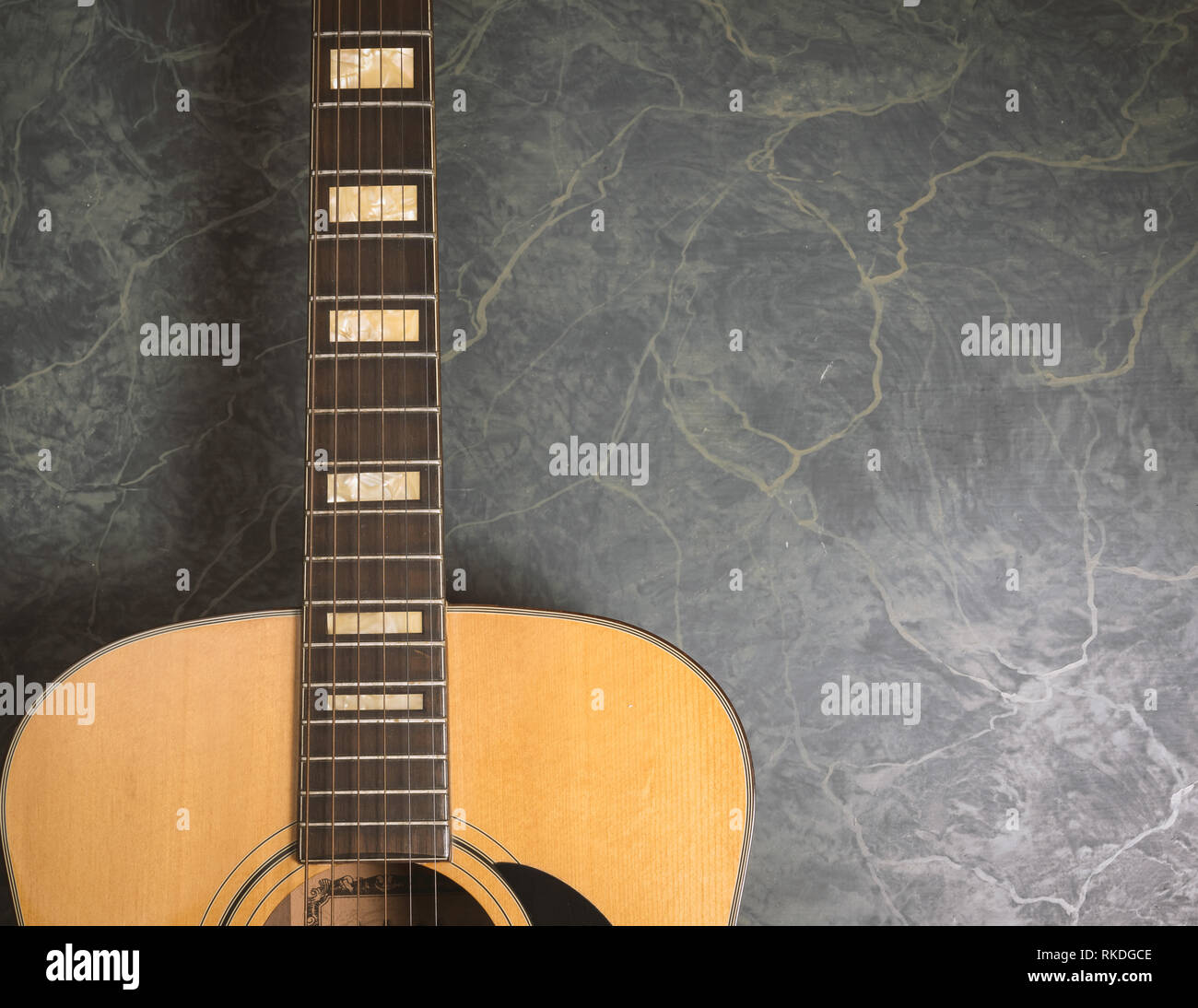 acoustic guitar on green marble background,music concept. Stock Photo