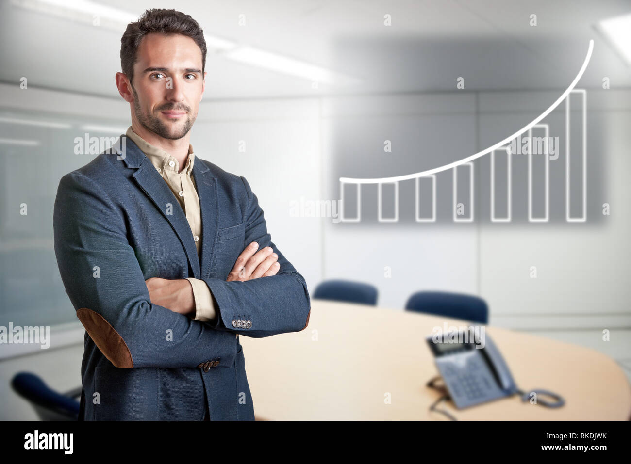Casual business man with arms crossed in a meeting room Stock Photo