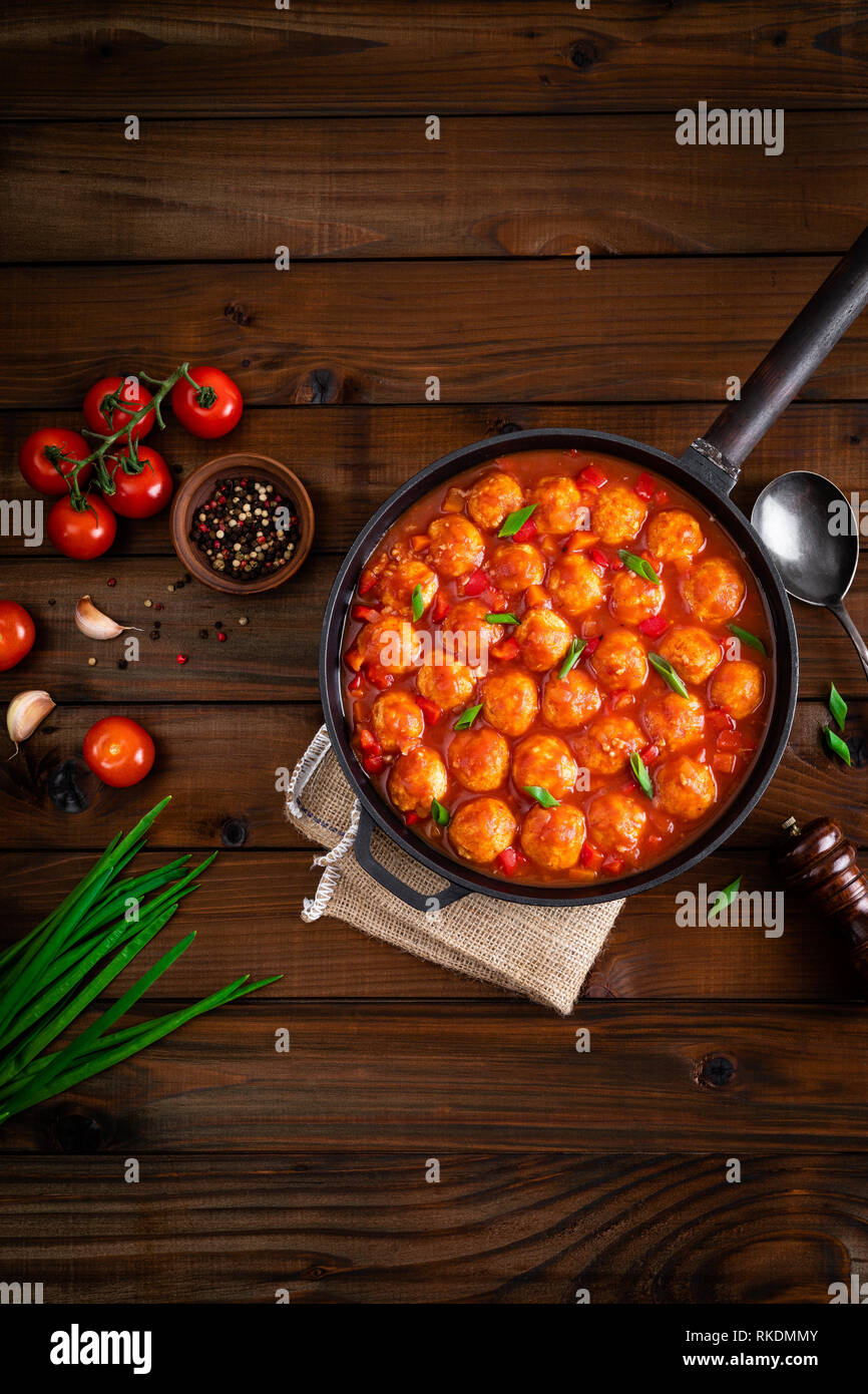 Chicken meatballs in spicy tomato sauce with vegetables in pan. Mexican cuisine Stock Photo