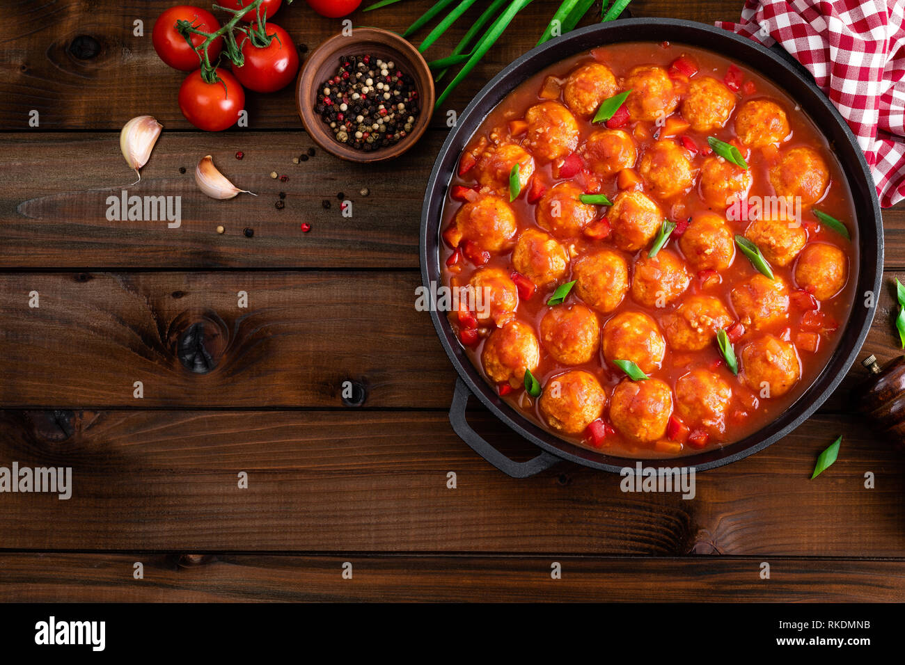 Chicken meatballs in spicy tomato sauce with vegetables in pan. Mexican