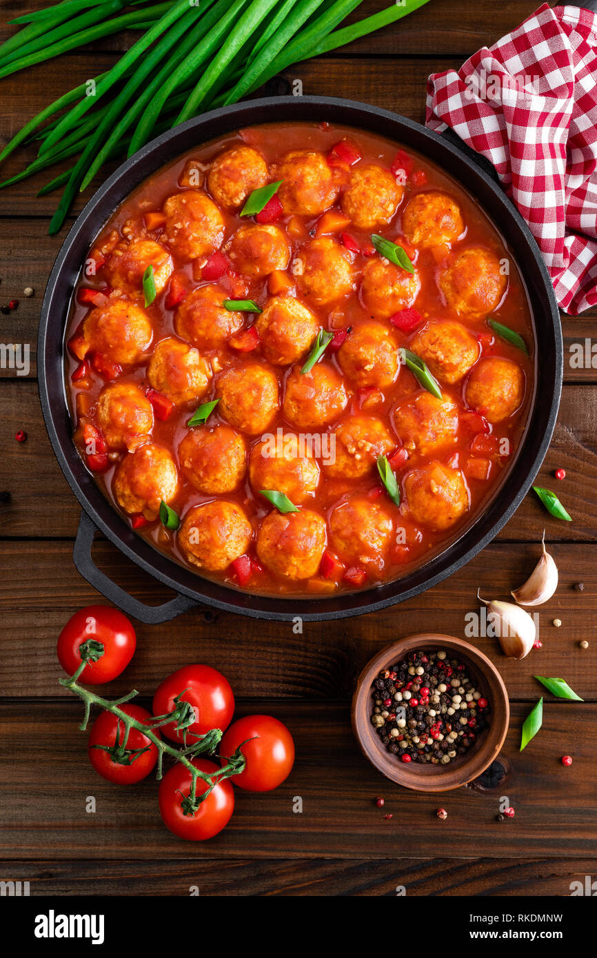 Chicken meatballs in spicy tomato sauce with vegetables in pan. Mexican cuisine Stock Photo