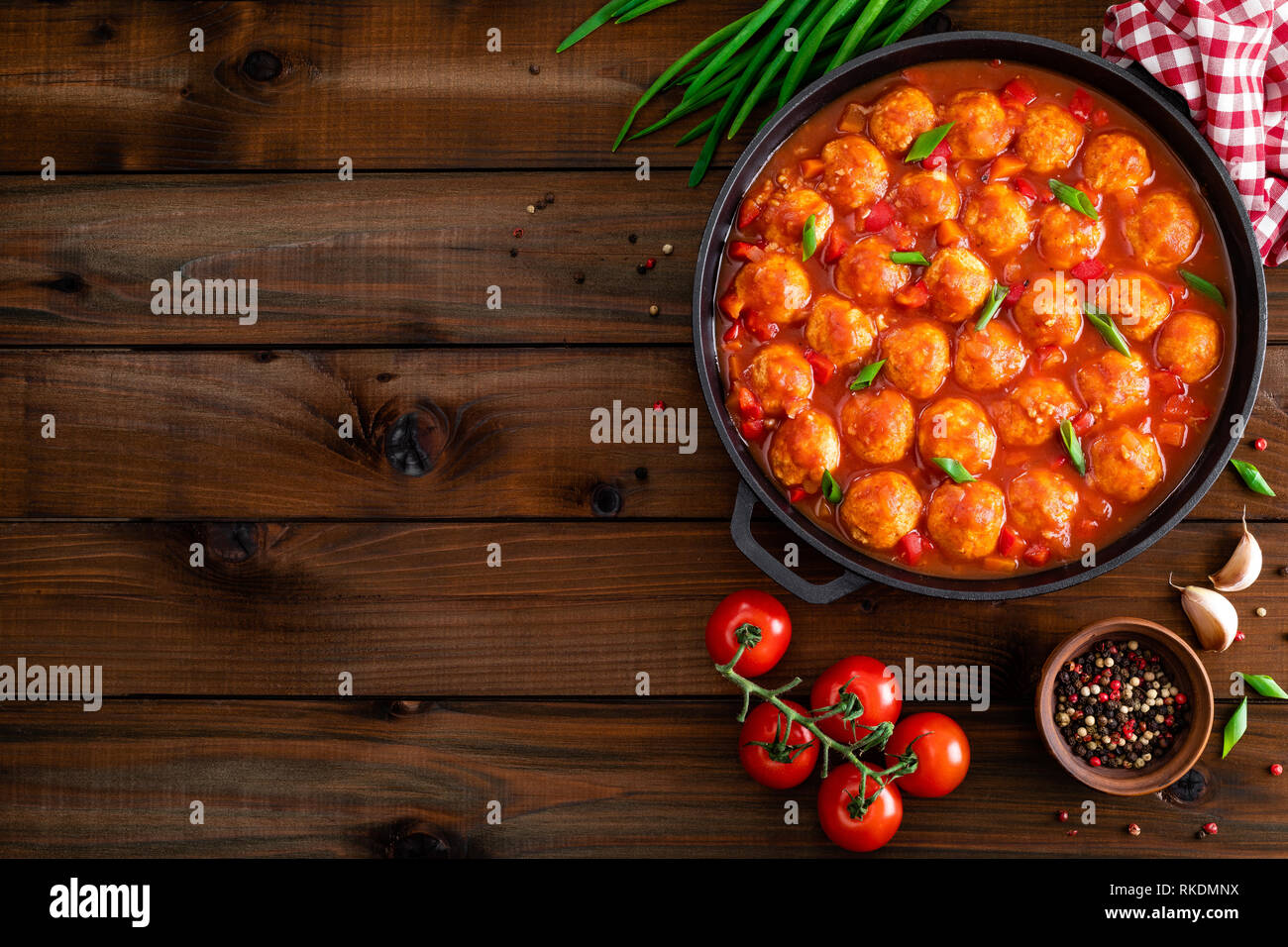 Chicken meatballs in spicy tomato sauce with vegetables in pan. Mexican cuisine Stock Photo