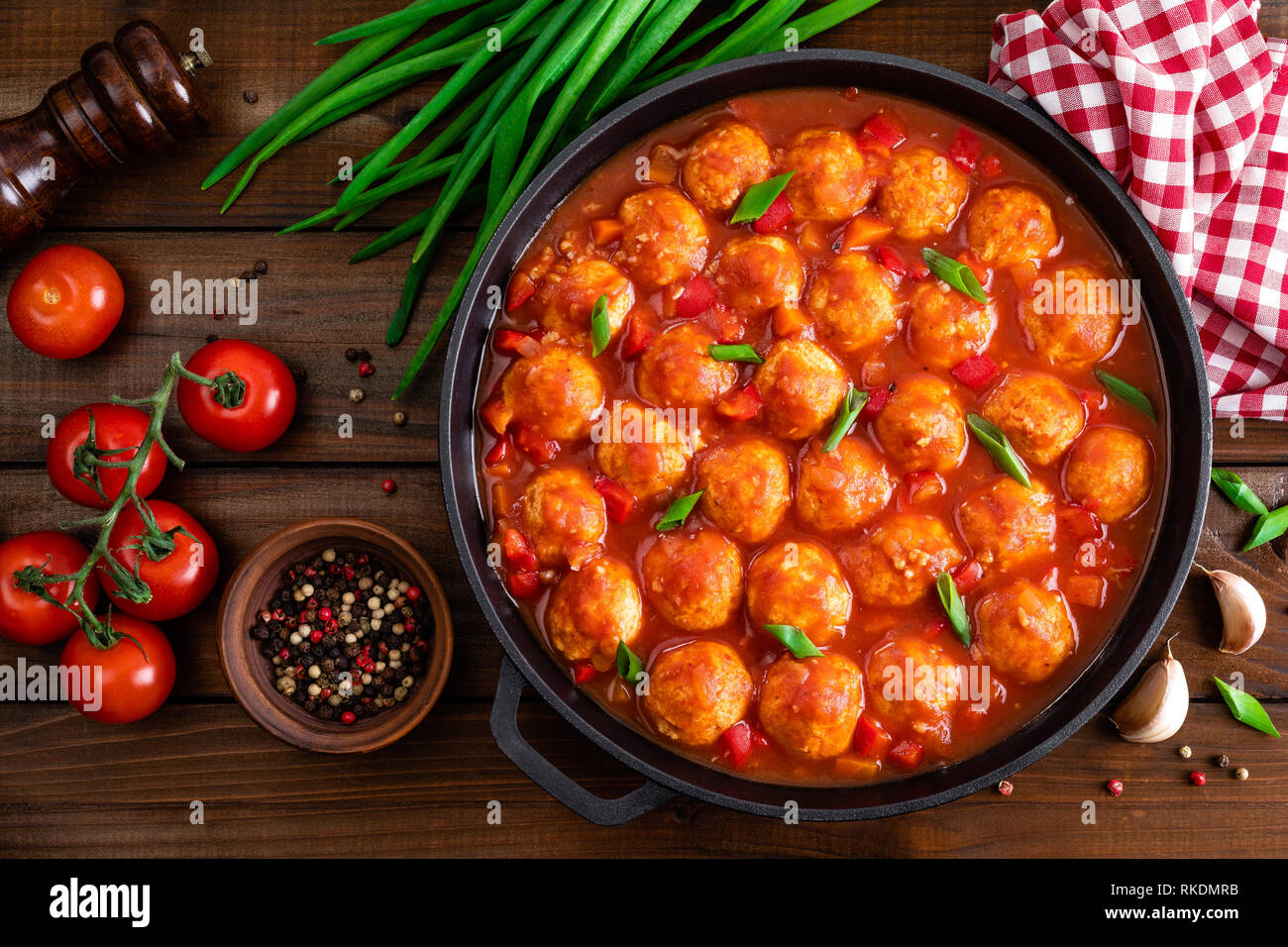 Chicken meatballs in spicy tomato sauce with vegetables in pan. Mexican cuisine Stock Photo