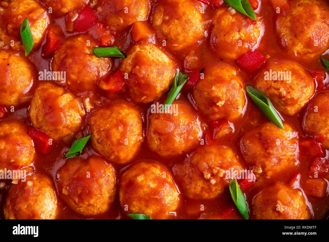 Chicken meatballs in spicy tomato sauce with vegetables in pan. Mexican cuisine Stock Photo