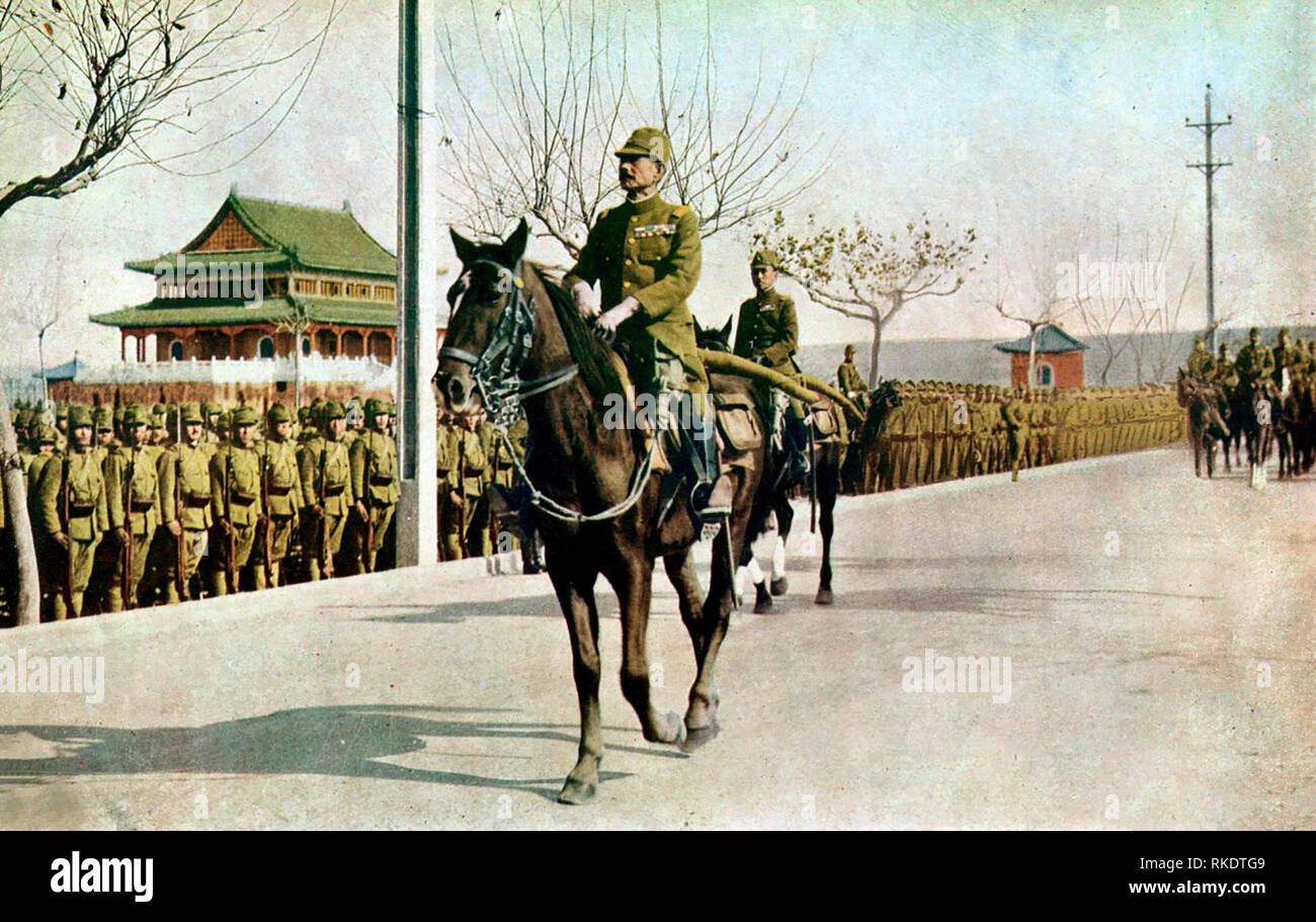 Iwane Matsui (in the foreground) and Prince Asaka (behind him) reviewing their troops on horseback during the entrance ceremony into Nanking following its fall to the Japanese Army. December 1937 Stock Photo