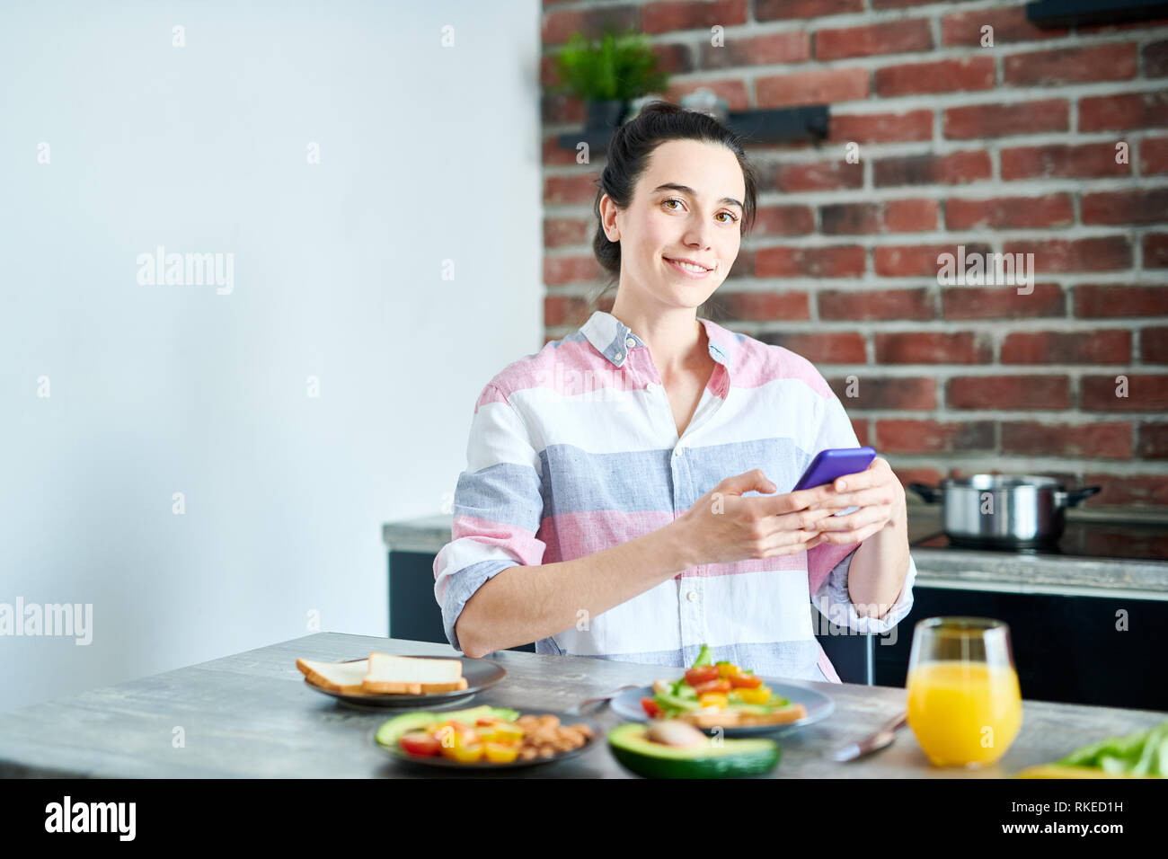Smiling Woman Enjoying Breakfast Stock Photo