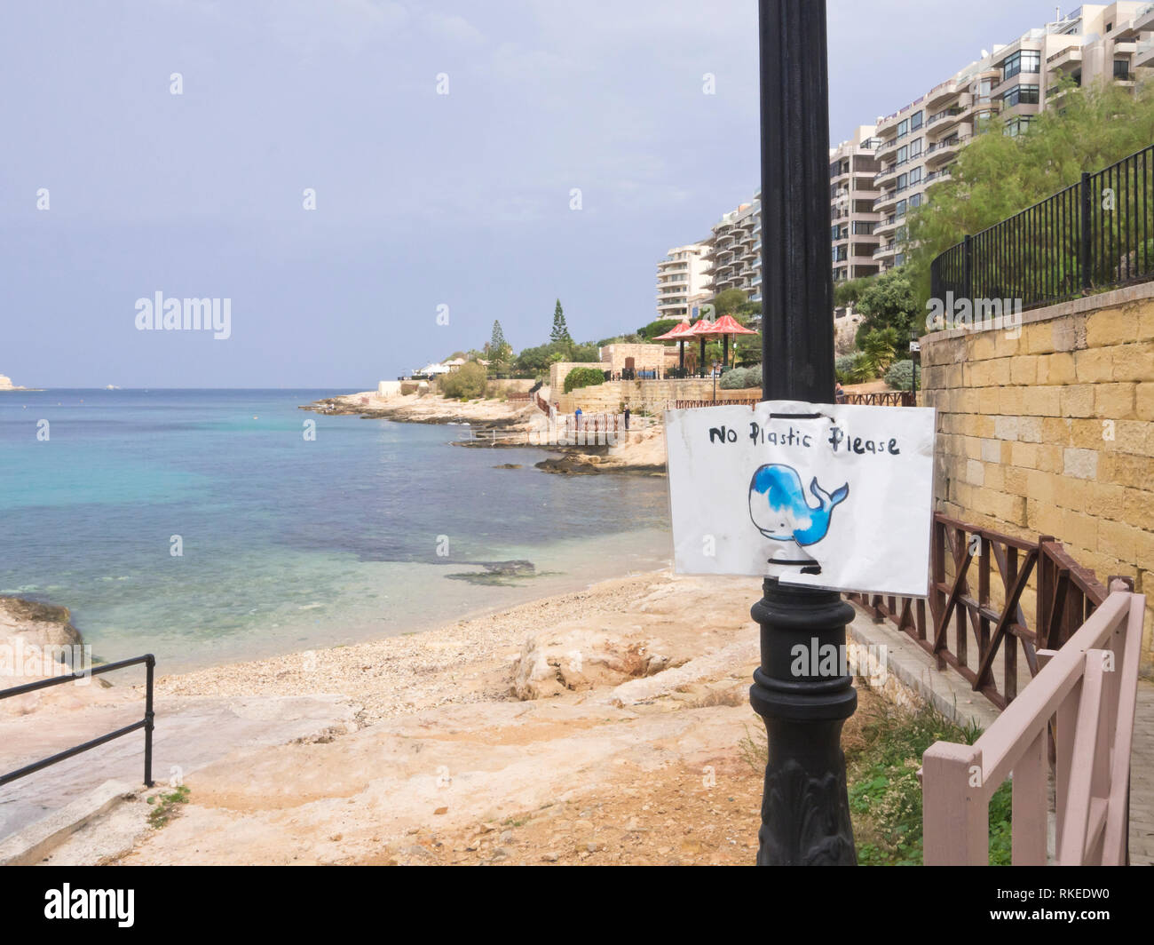 'No plastic please' humorous but important sign for environmental protection on the beach and coastal promenade in Sliema Malta Stock Photo