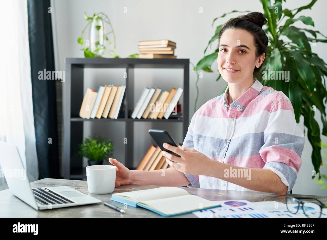 Young Woman at Workplace Stock Photo