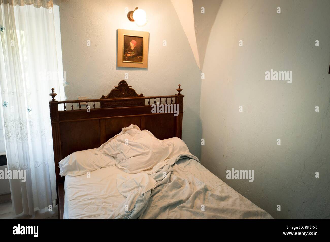 Unmade bed in townhouse bedroom. Santo-Pietro-di-Tenda, Corsica, Francia. Stock Photo