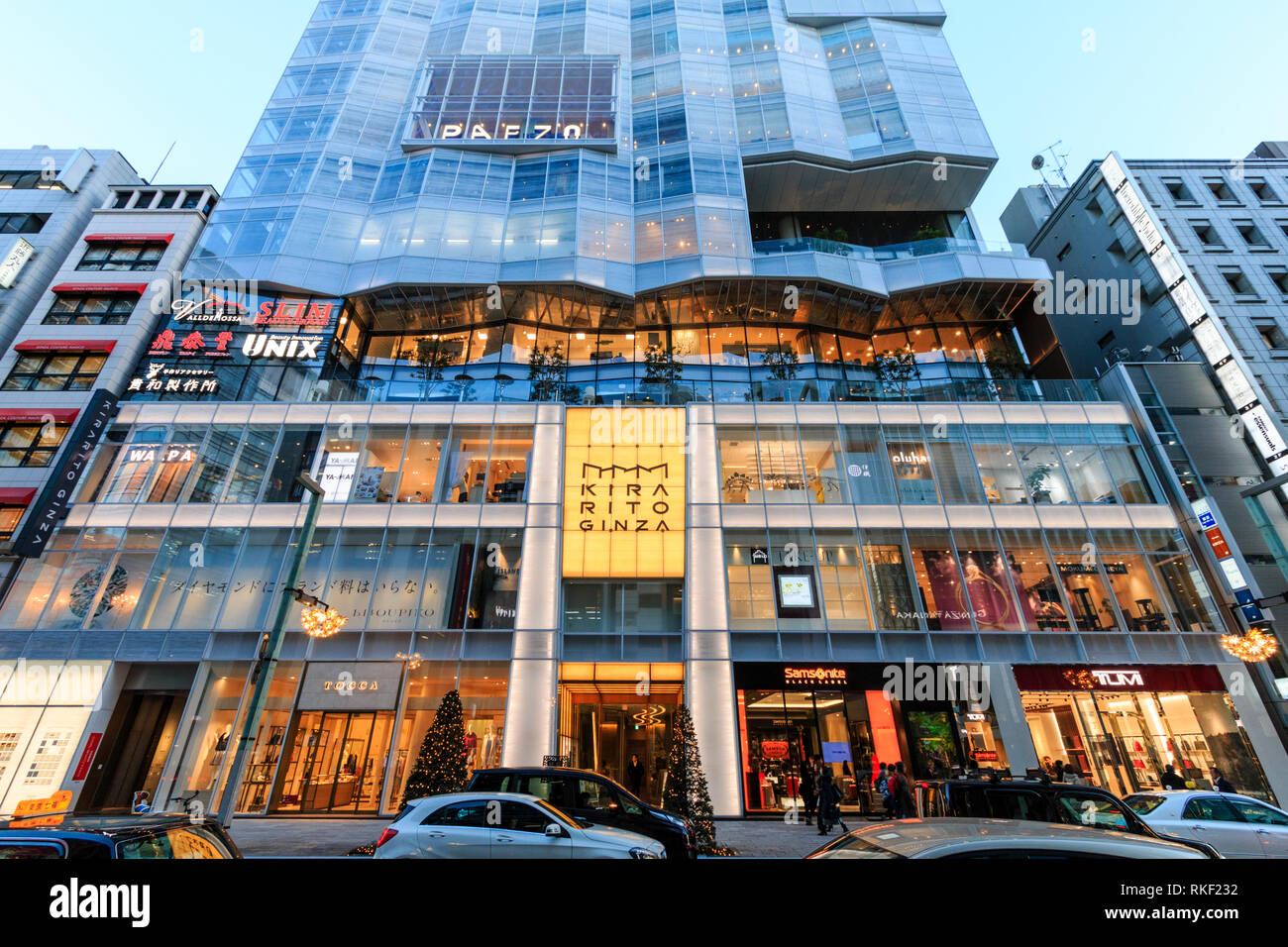 Tokyo Ginza Golden Hour Kirarito Ginza High End 12 Story Shopping Center Building With Christmas Trees Outside On Pavement Traffic In Foreground Stock Photo Alamy