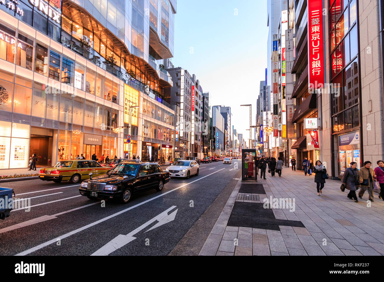 Tokyo Ginza Golden Hour View Along Street With Kirarito Ginza High End 12 Story Shopping Center Building With Christmas Trees Outside On Pavement Stock Photo Alamy