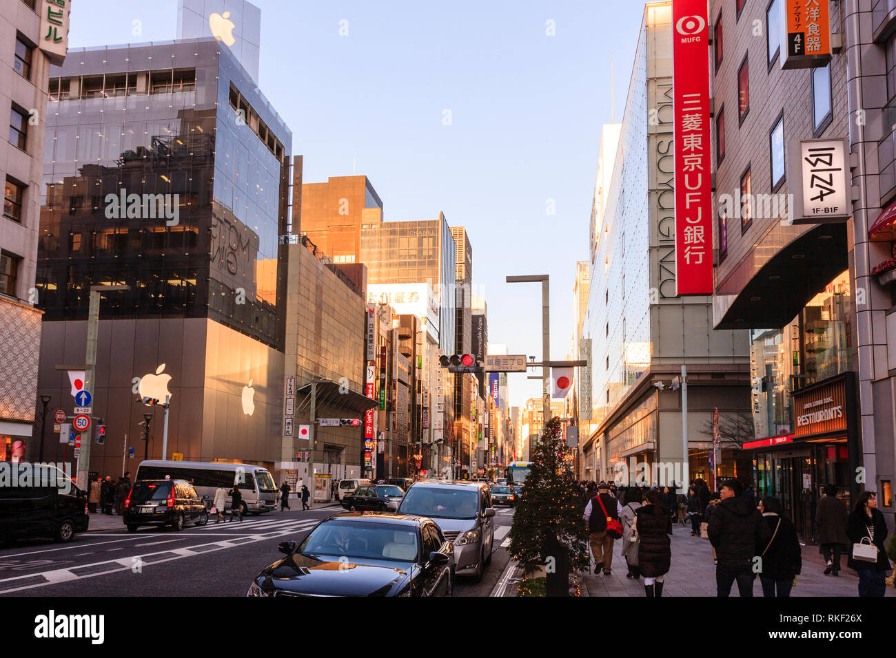 Tokyo Ginza At Golden Hour View Along Street And Matsuya And Apple Stores Pavement Busy With Shoppers Illuminated Christmas Trees On Sidewalk Stock Photo Alamy