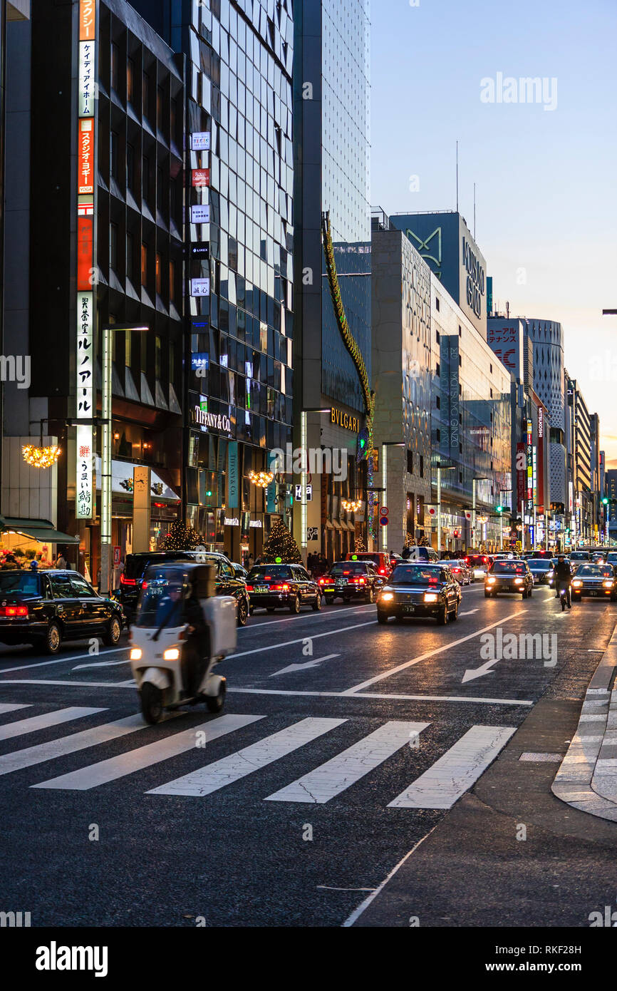 Tokyo, Ginza at golden hour. View along street, Louis Vuitton and the  Bvlgari flagship store buildings with taxis waiting at red stop light in  front Stock Photo - Alamy