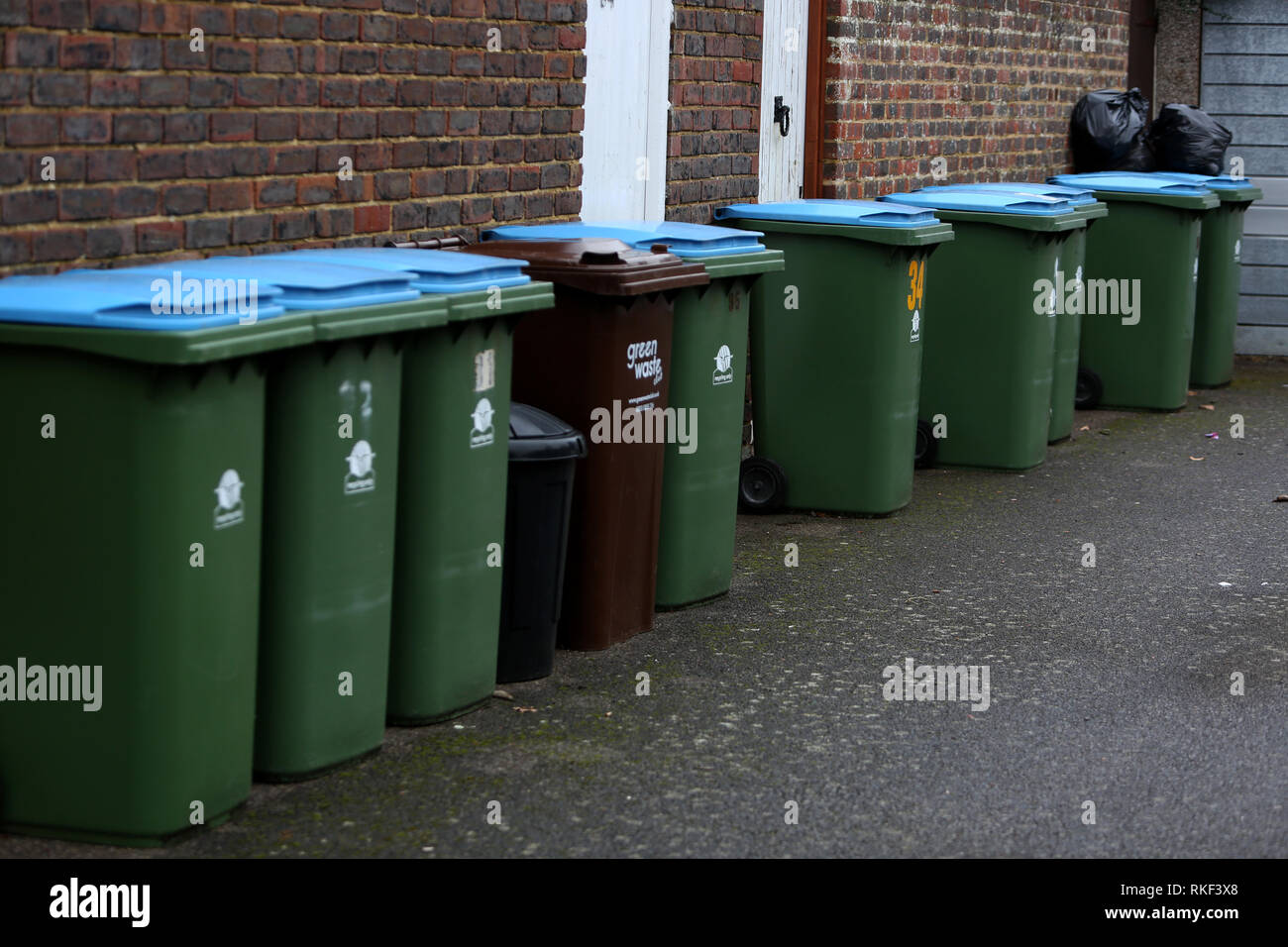 General view of some domestic bins in a street in Bognor Regis, West Sussex, UK. Stock Photo