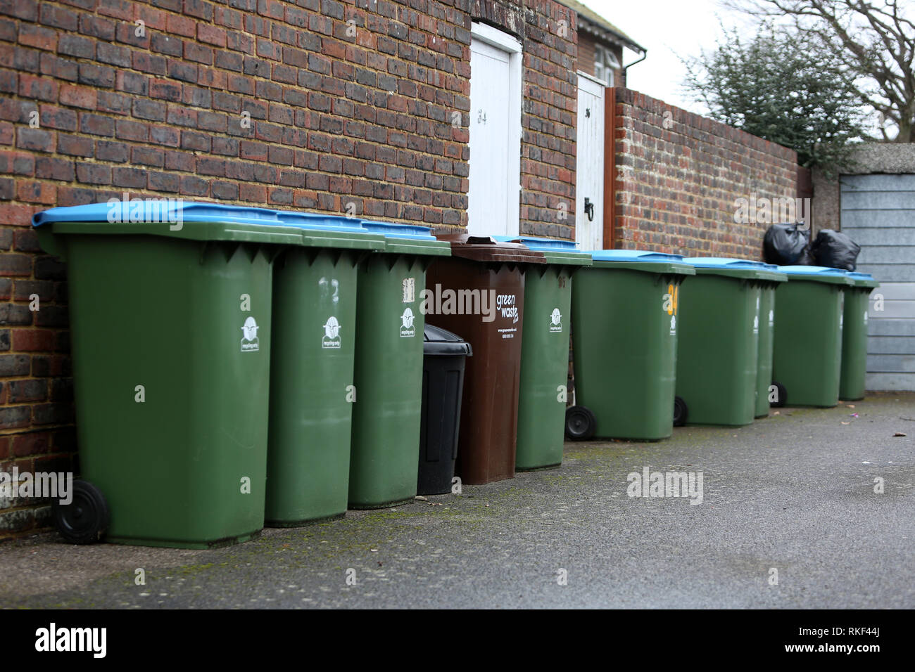 General view of some domestic bins in a street in Bognor Regis, West Sussex, UK. Stock Photo