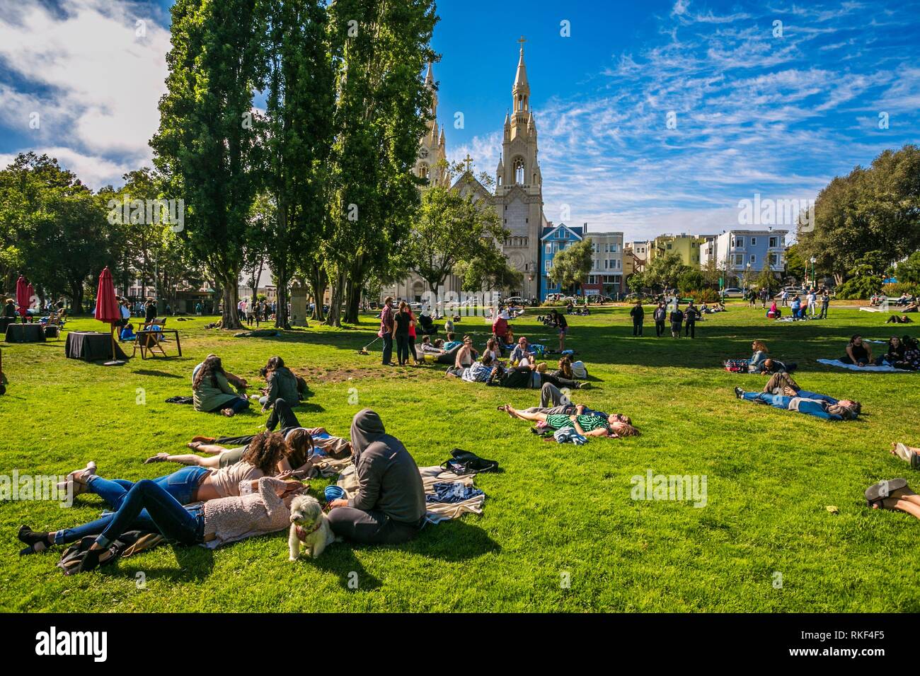 Sunday Afternnon Relaxation, Washington Square with view of Saints Peter and Paul Catholic Church, San Francisco, California, USA Stock Photo