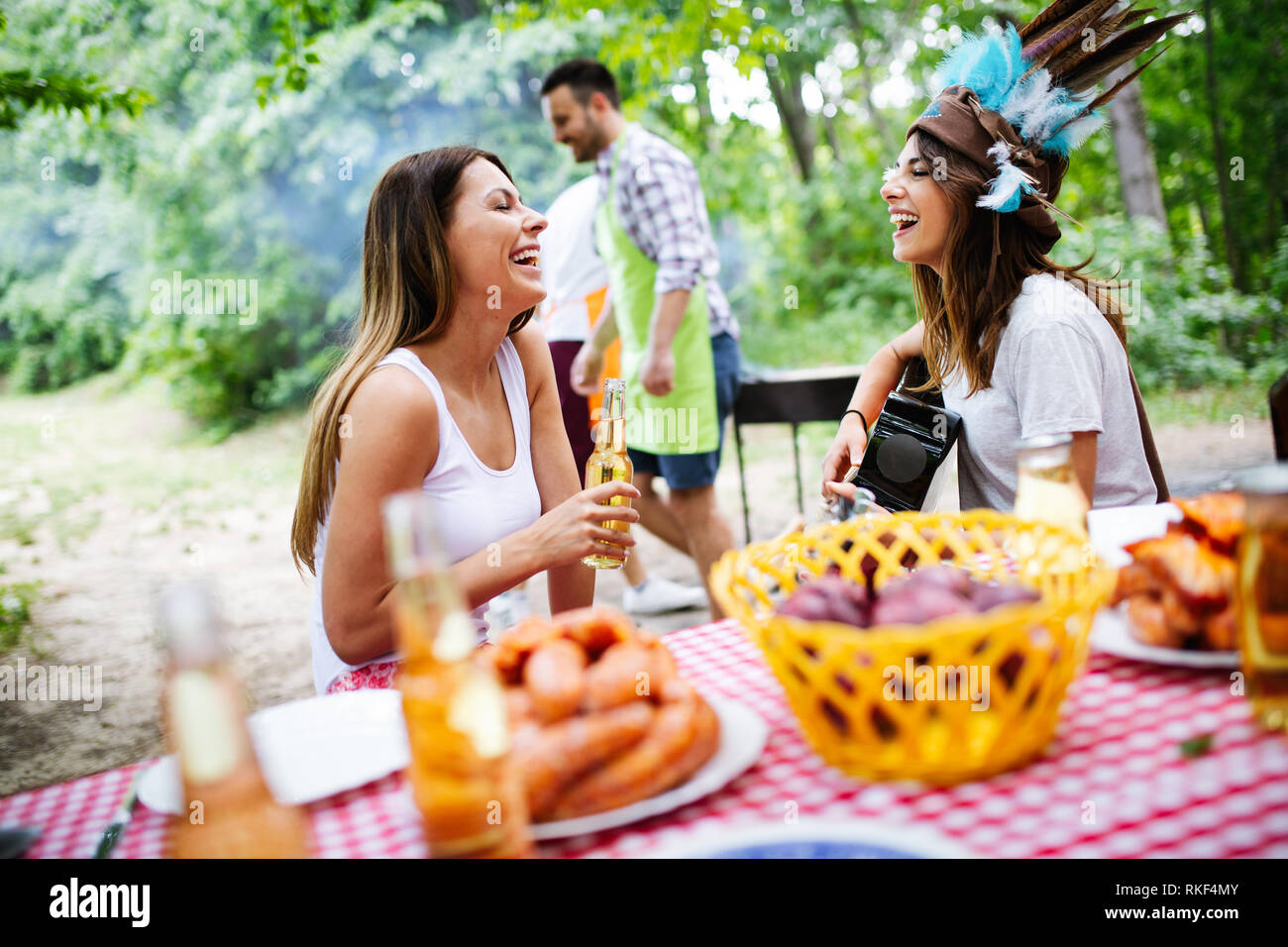 Group of happy friends having a barbecue party in nature Stock Photo ...