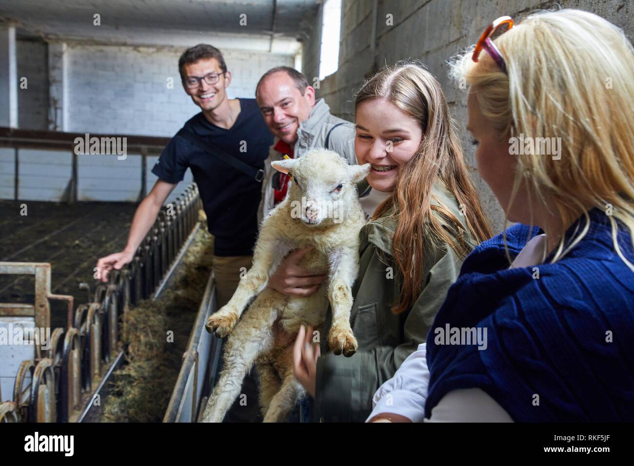 Tour guide with group, Girl with lamb, Caserio Mausitxa, Elgoibar, Gipuzkoa, Basque Country, Spain, Europe Stock Photo
