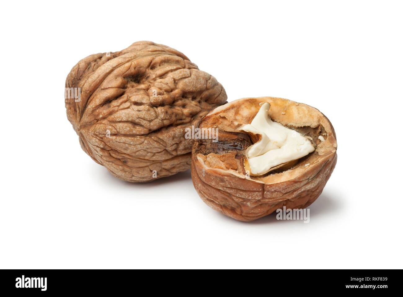 Whole and half wet walnut on white background. Stock Photo