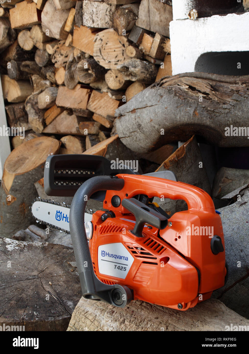Brand new Husqvarna T425 Chain Saw on woodpile ready fro use Stock Photo -  Alamy