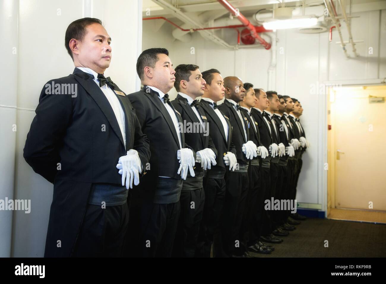 Butlers ready for briefing before starting work in a cruise passenger ship,asian butlers,indian butlers,pradeep subramanian Stock Photo