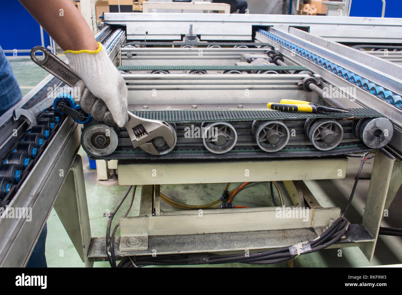 worker maintenance and repair conveyor belt in factory Stock Photo Alamy