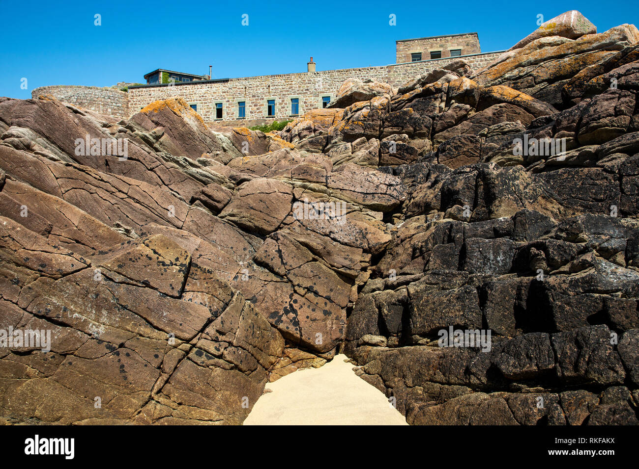 The dominating position of Fort Corblets on Alderney, taken from the beach. Stock Photo