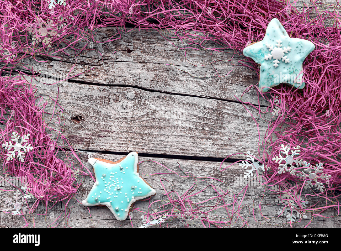 Turquoise star shape with pink decorations on gray wood background with copy space. Stock Photo