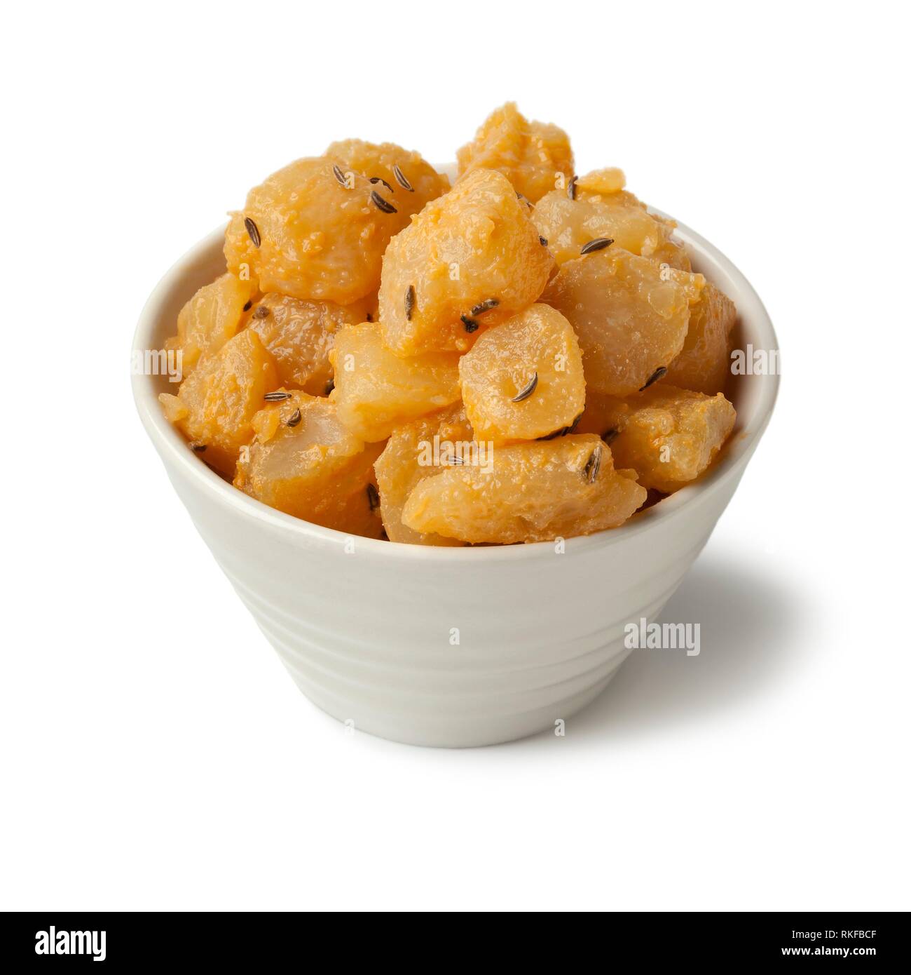 Traditional Slovak pieces of hand cheese with caraway seeds in a bowl on white background. Stock Photo