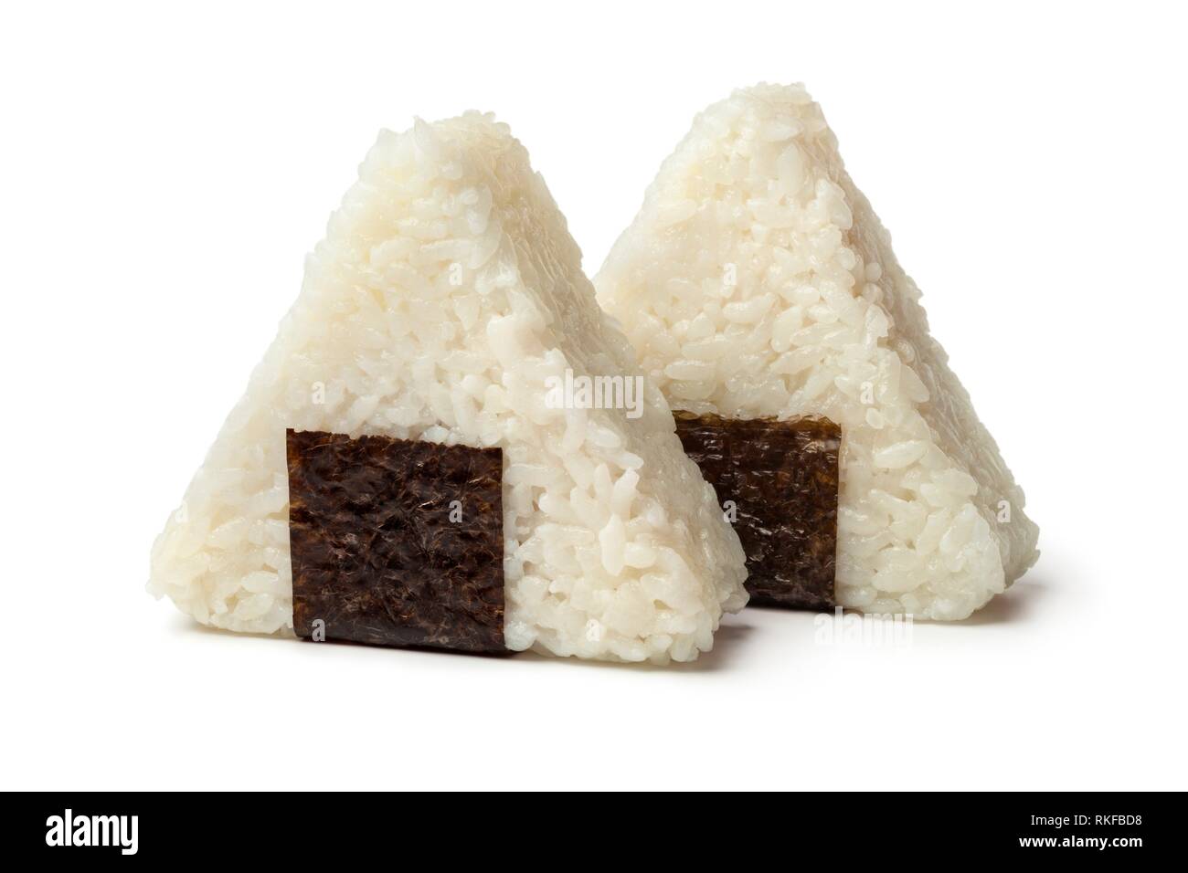 Fresh made Japanese triangular onigiri on white background. Stock Photo