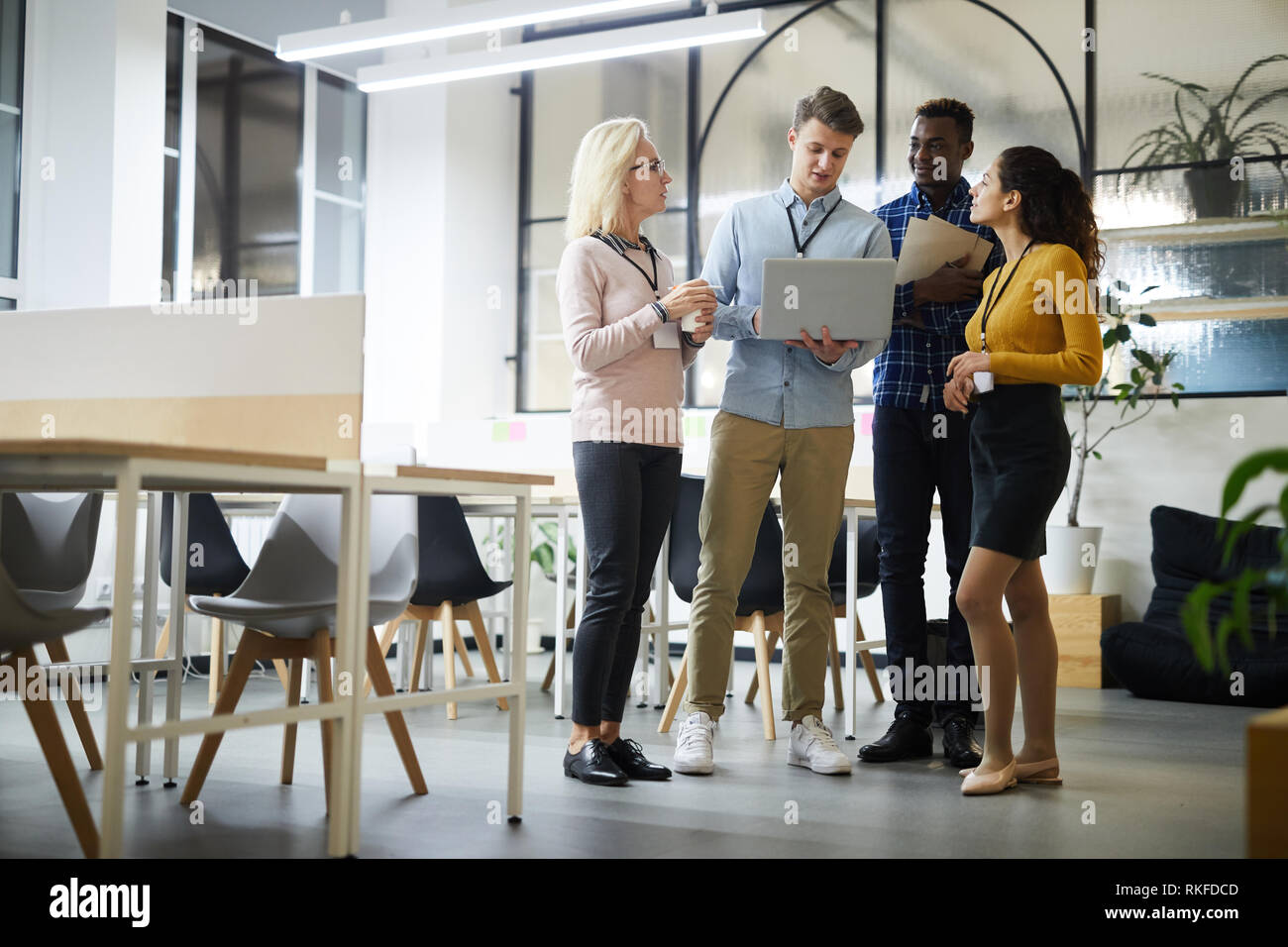 Colleagues analyzing online data in coworking space Stock Photo